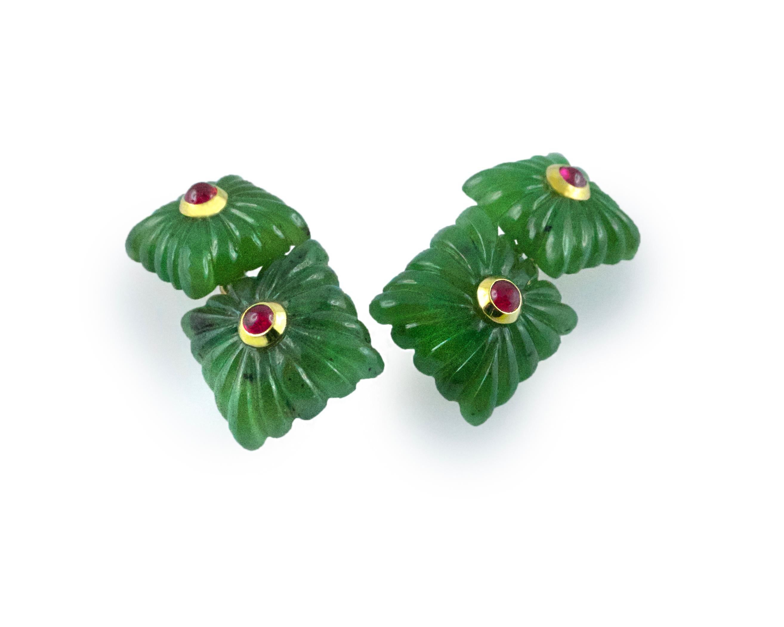 These exquisite cufflinks are made entirely of jade and feature a squared front face and a smaller, identically shaped toggle, both made of jade with the traditional “fesonato” texture. The center of each square is highlighted with a cabochon ruby