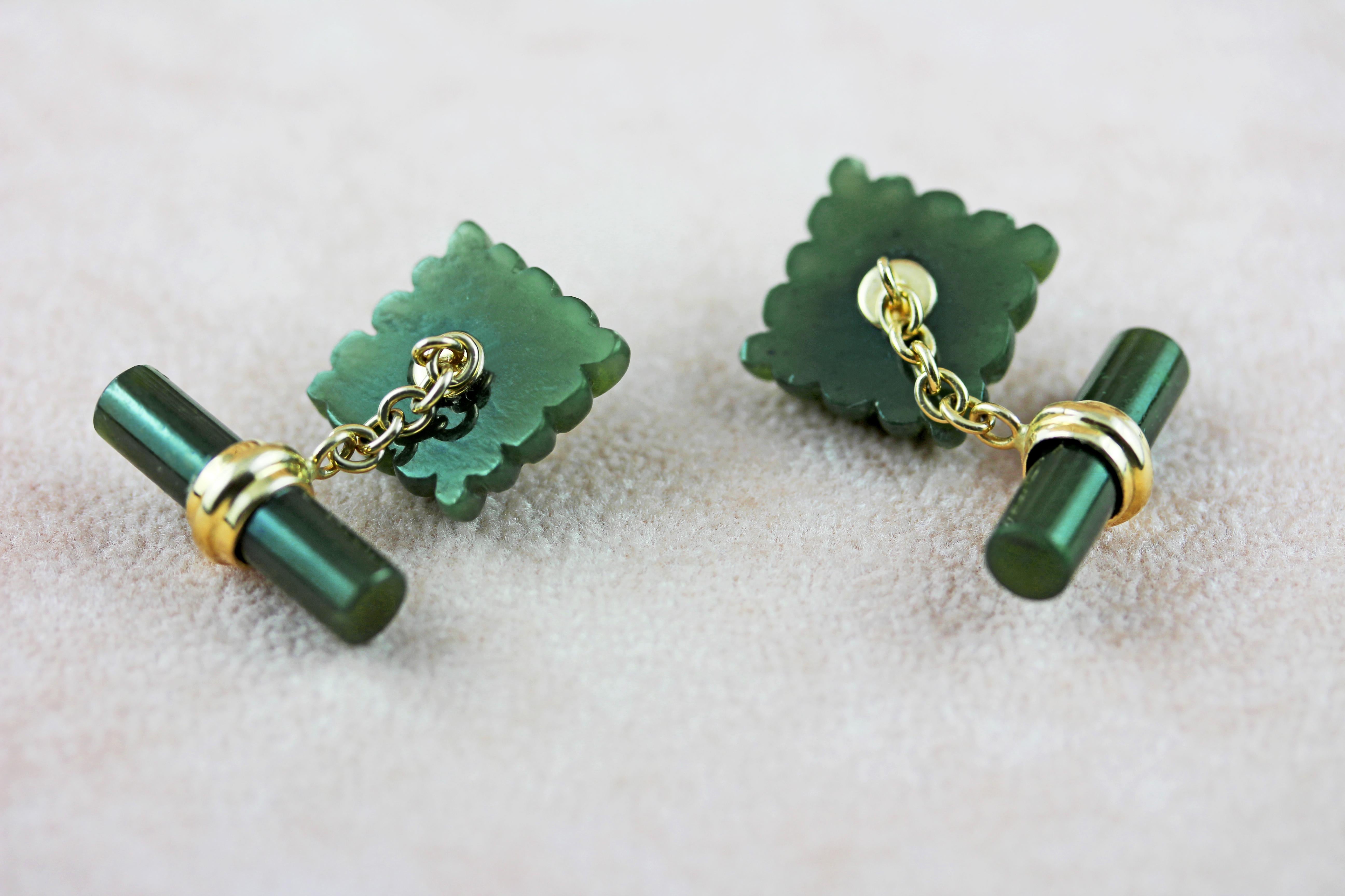 These exquisite cufflinks are made entirely of jade with a squared front face and a cylindrical toggle. 
The deep, warm shade of the jade is accented at the center of each front face with a cabochon ruby. 
The post and the mounting of the rubies are