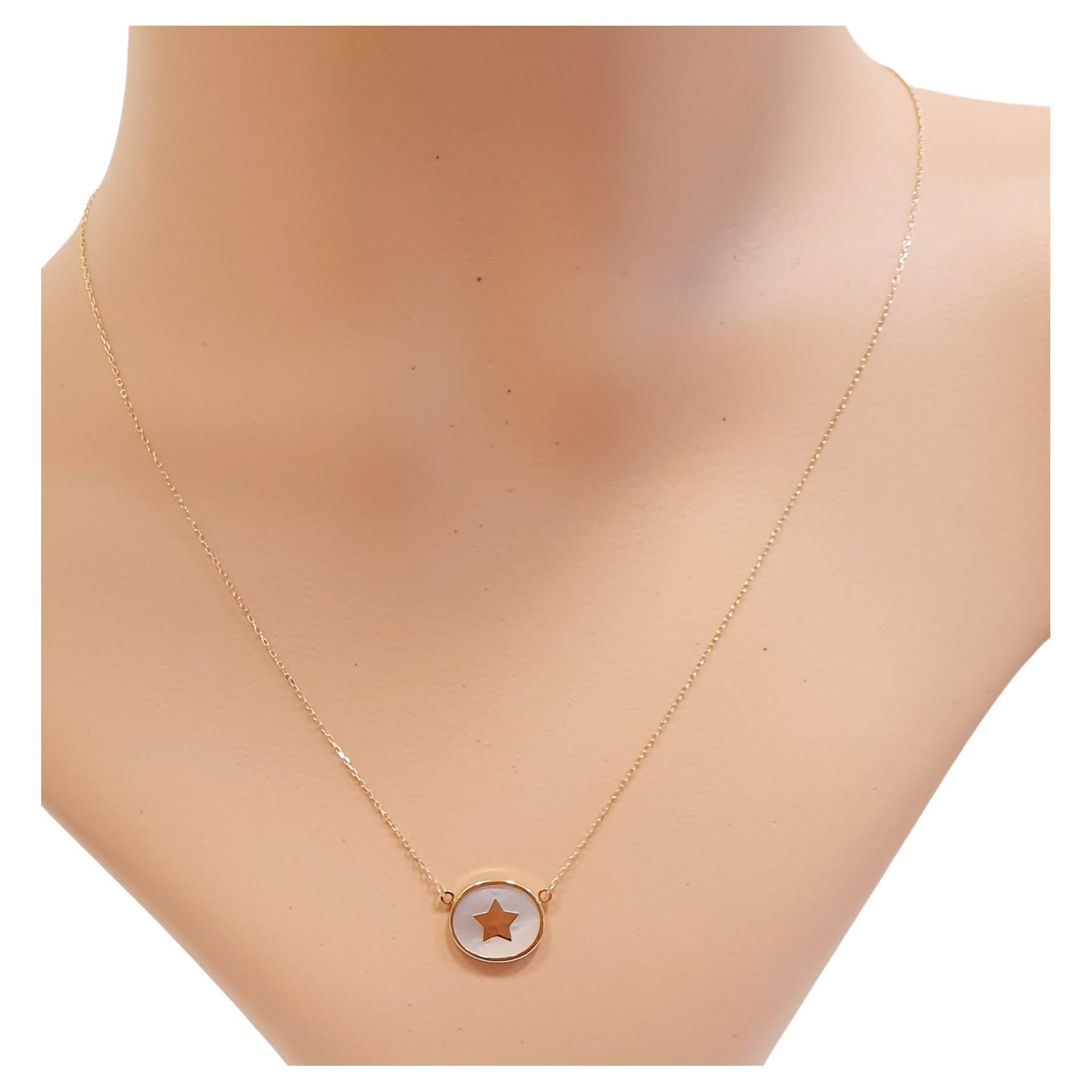  18 karat Yellow Gold Chain  with a white Nacre Pendant  and a Central Gold Star
Sea Star Charm collection, inspired in the Mediterranean sea colours and gold tokens ....

READY TO SHIP
*Shipment of this piece is not affected by COVID-19. Orders