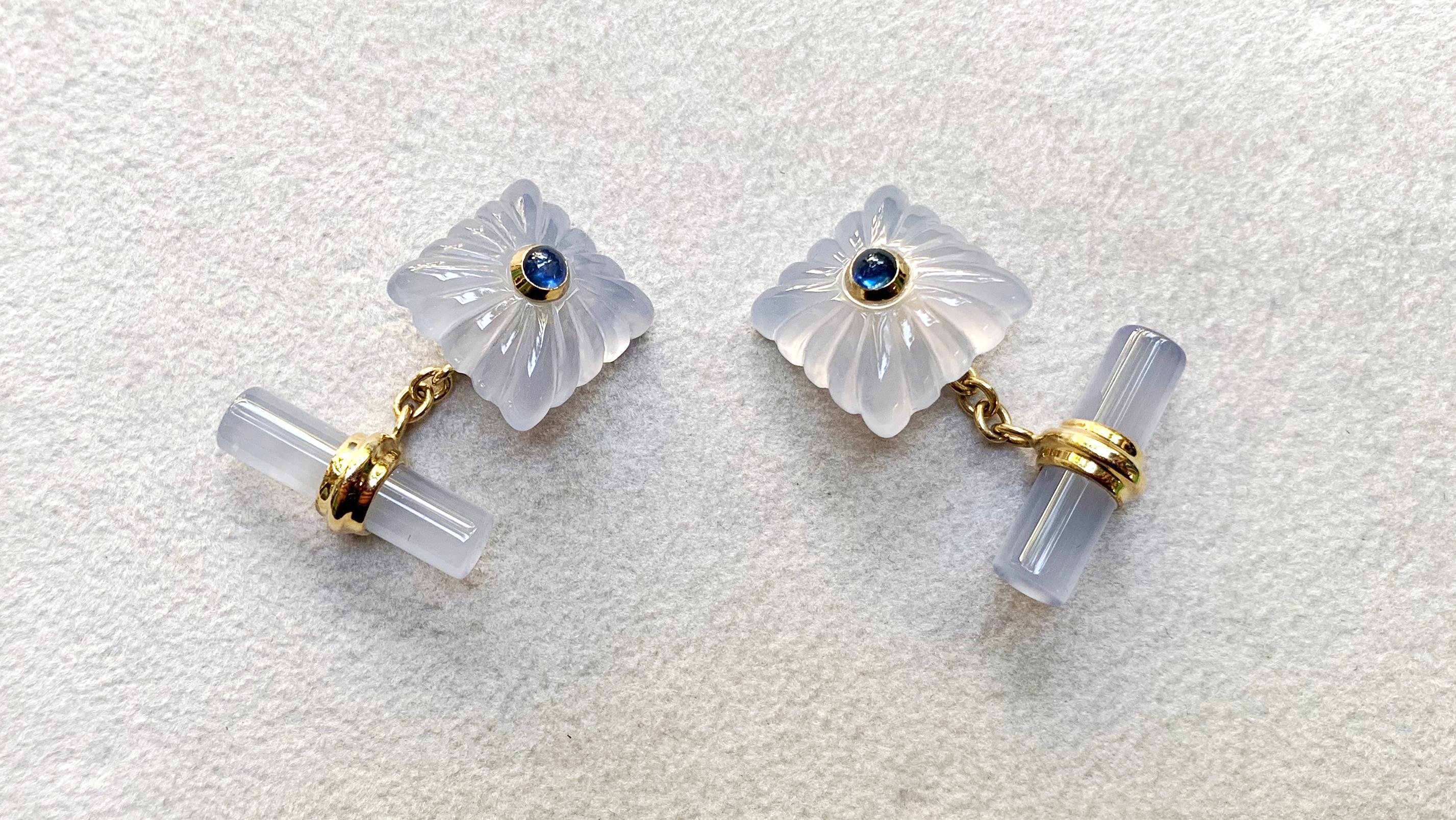 This timeless pair of cufflinks is made entirely of chalcedony, whose pearly white shade is shaped as a cylinder for the toggle and as a square with “fesonato” texture for the front face. The square is accented with a cabochon sapphire mounted in