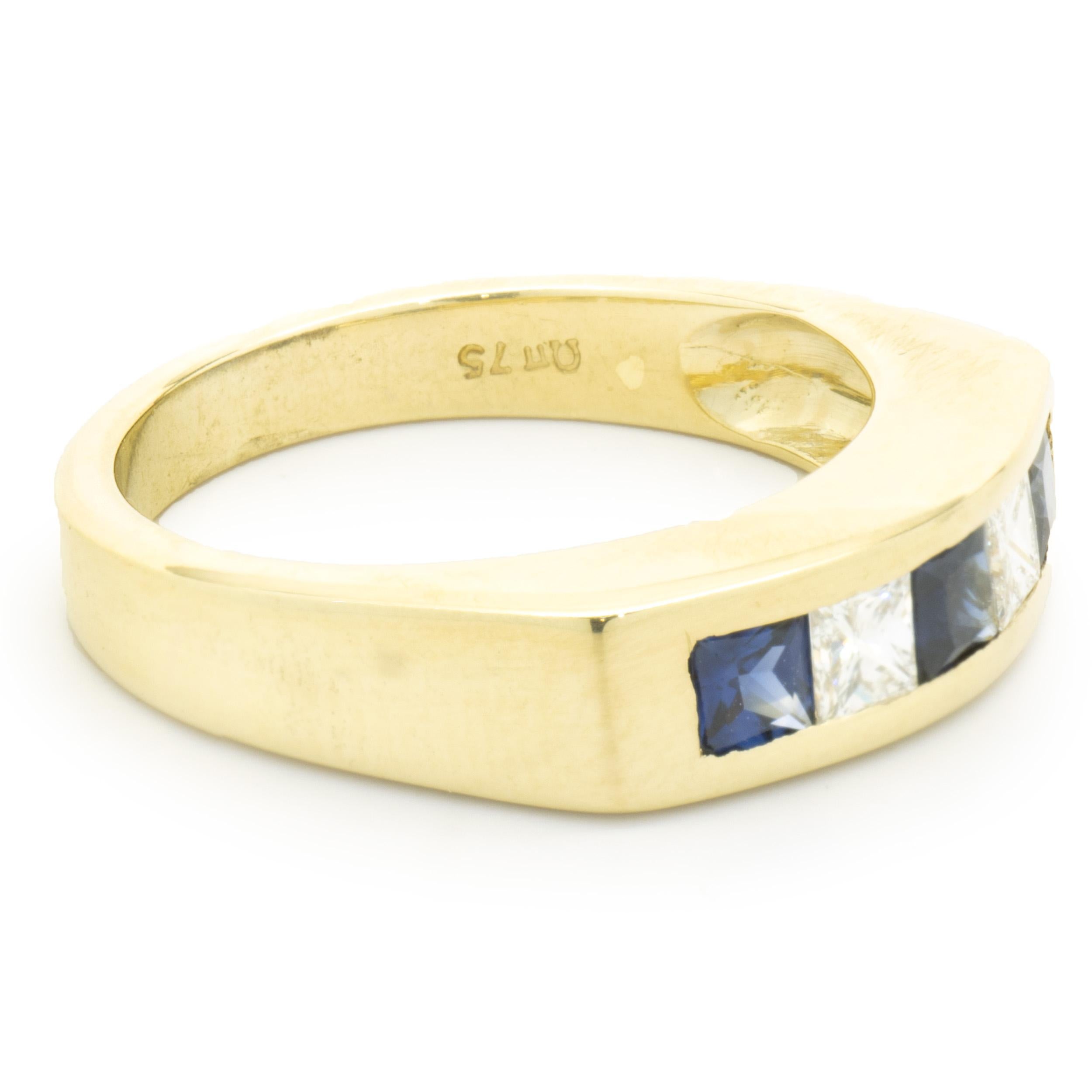 Designer: custom design
Material: 18K yellow gold
Diamond: 2 princess cut = 0.24cttw
Color: H
Clarity: VS1
Sapphire: 3 princess cut = 0.45cttw
Dimensions: ring top measures 5mm wide
Ring Size: 7 (please allow two extra shipping days for sizing