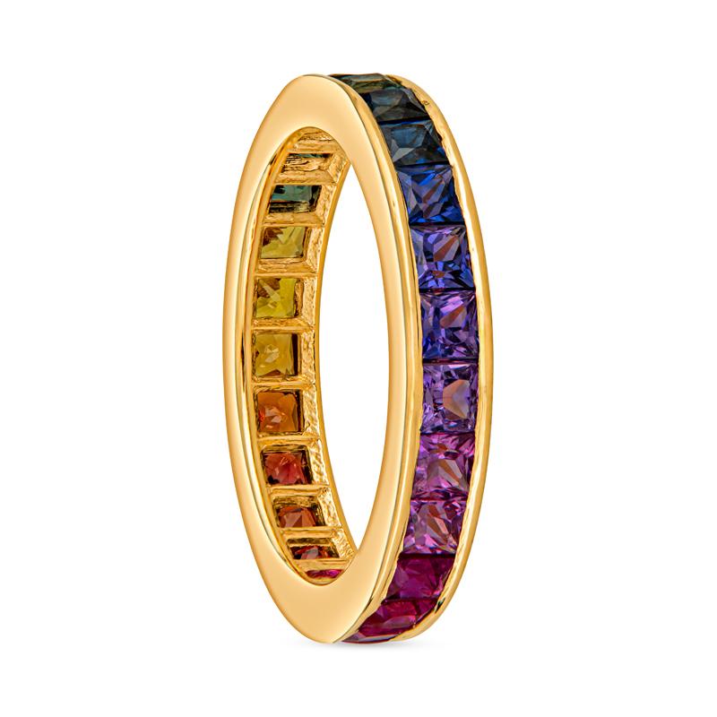 This 18 karat yellow gold ring features 2.40 carat total weight in channel-set princess cut multi colored sapphires. Wear alone or stack with other bands! This ring is a size 6. 
Measurements: Width approximately 3.40mm