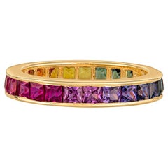 18 Karat Yellow Gold Channel Set Rainbow Princess Cut Sapphire Eternity Band