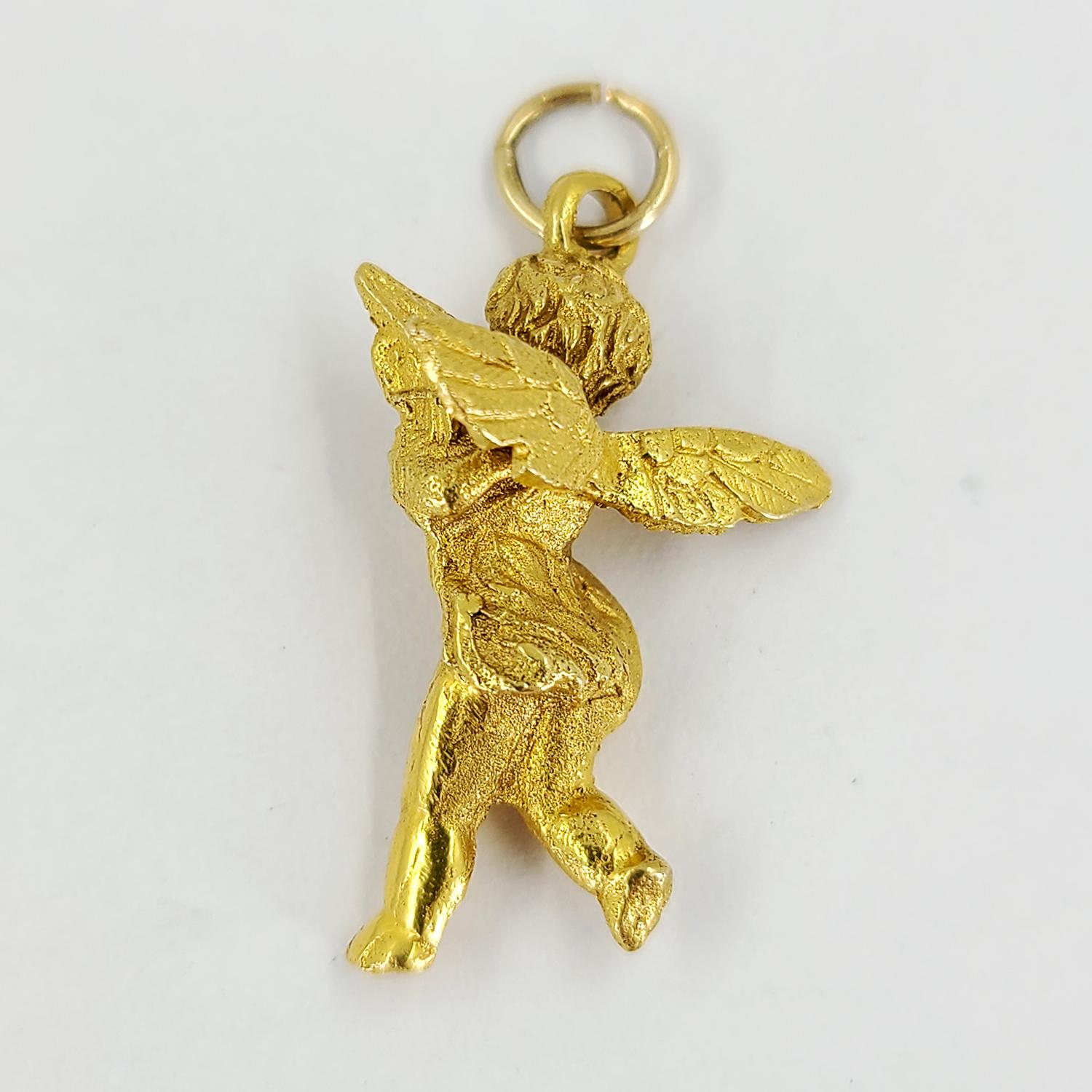 18 Karat Yellow Gold Cherub Charm Pendant Featuring Brushed Texture. Finished Weight Is 4.8 Grams. 1 Inch Length.