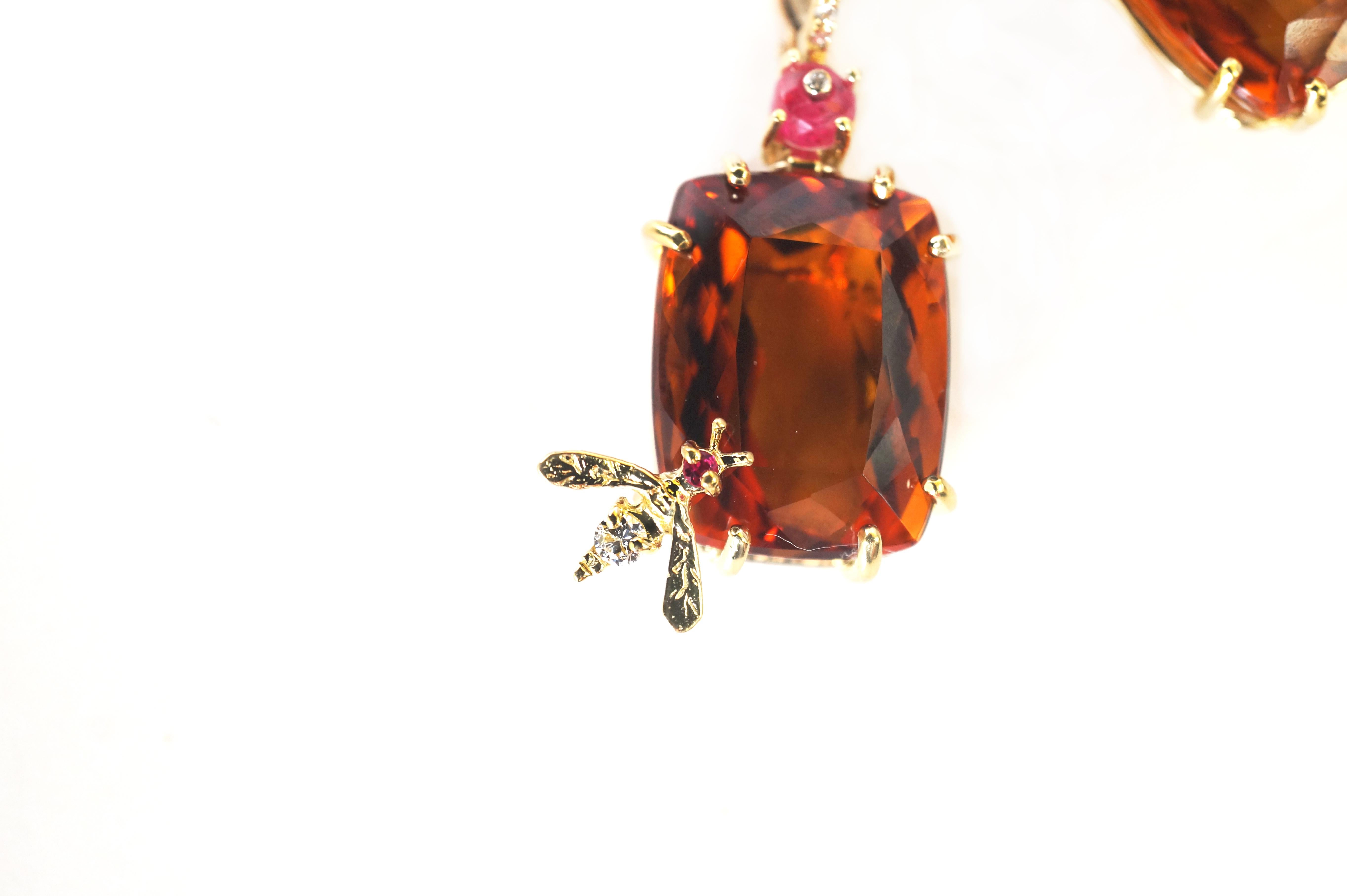 Citrine and Spinel Bee Earrings
A pair of cushion-cut citrine earrings, each suspended via a white  diamond encrusted earwire via a red spinel that has been set with a white diamonds, in eighteen-karat yellow gold.  A bumblebee, set with a round