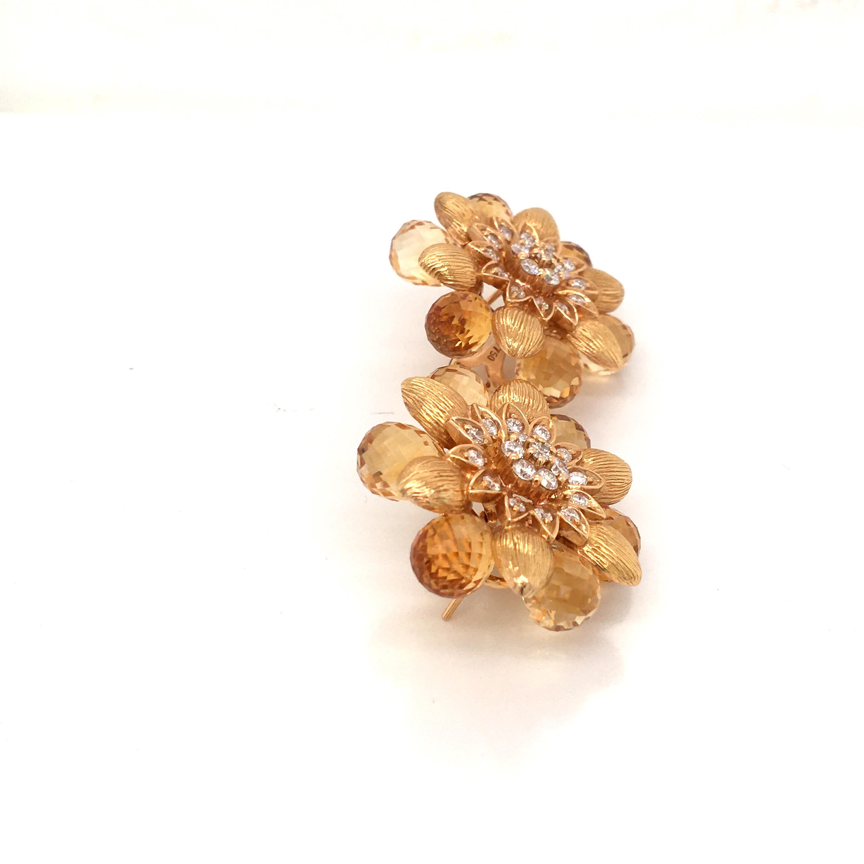 18 Karat yellow gold pair of earrings set with diamonds cts 1.44 color  G  clarity  VS  and sourranded by briolette cut citrine made in Italy come in a box.
very unique pair of earrings, alot of work to make this special design 
for pierced ears,