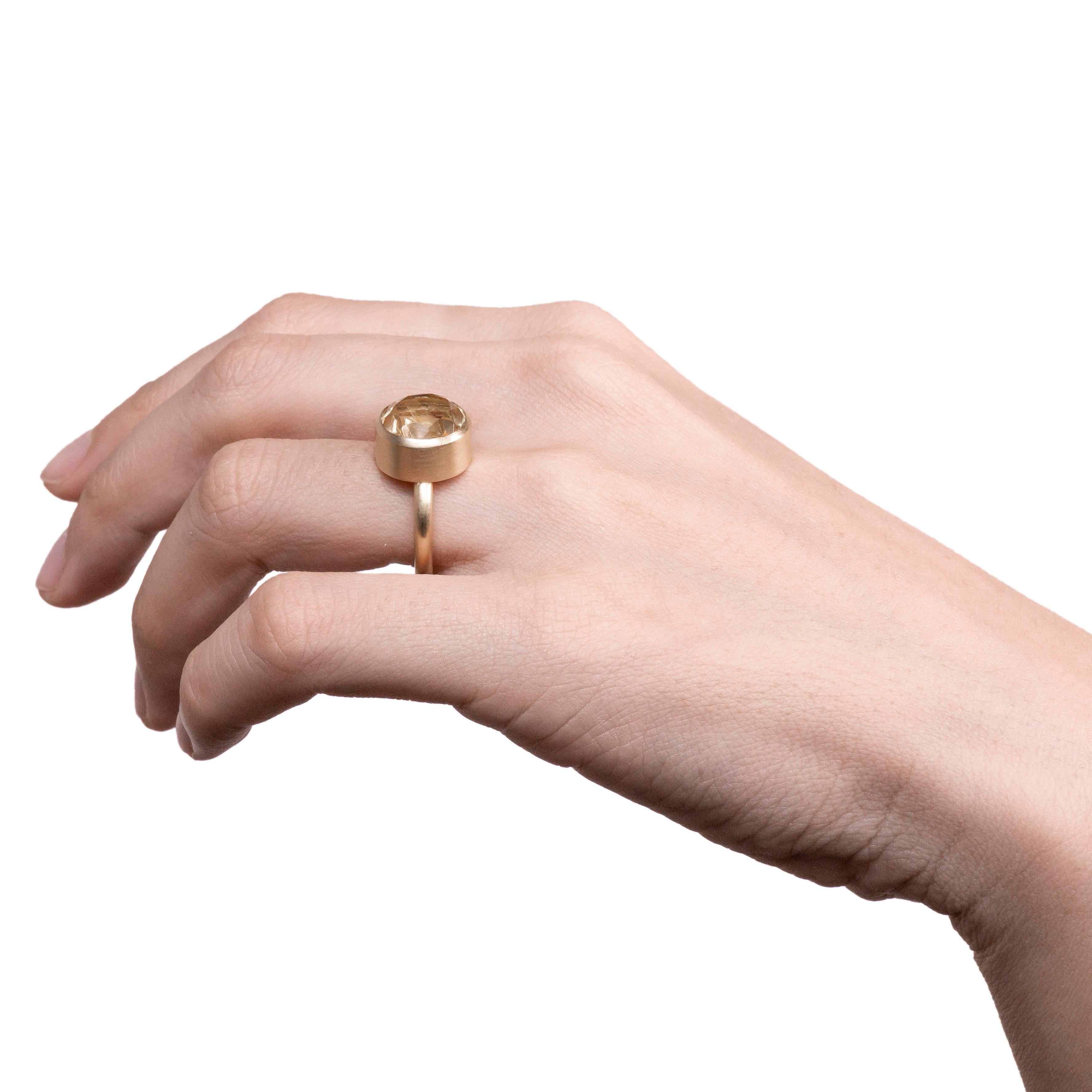 This bold and minimal statement ring is a modern take on the cocktail ring. It features a stone that is fashioned from two natural colored stones that have been fused together then cut and polished as one. When the two characteristics of the