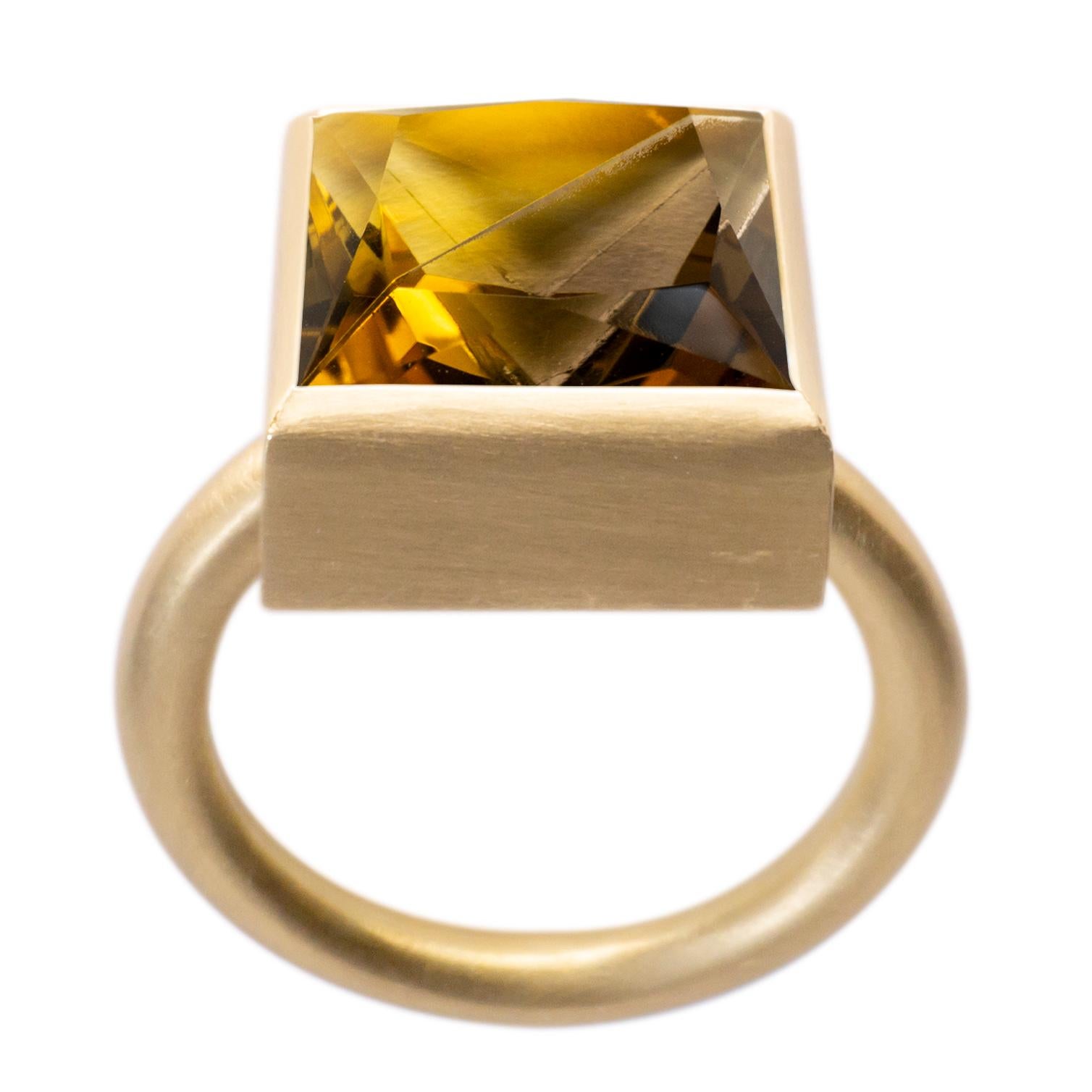 This bold and minimal statement ring is a modern take on the cocktail ring. It features a stone that is fashioned from two natural colored stones that have been fused together then cut and polished as one. When the two characteristics of the