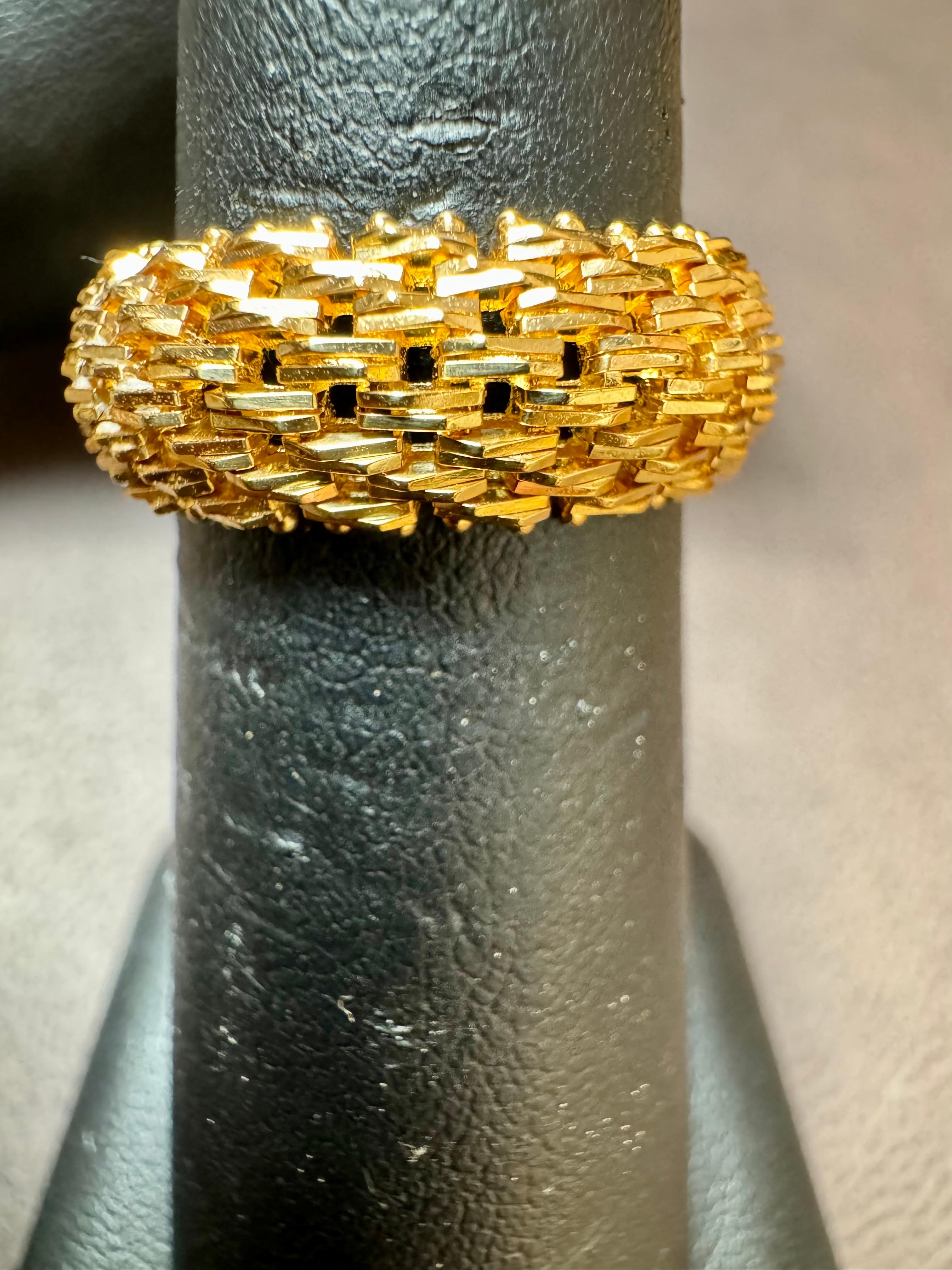 Introducing an 18 Karat Yellow Gold Classic Wide Wedding Band with a unique design, available in a unisex size 5.5. This timeless piece features a light classic net design that elegantly wraps around the entire band, adding a touch of