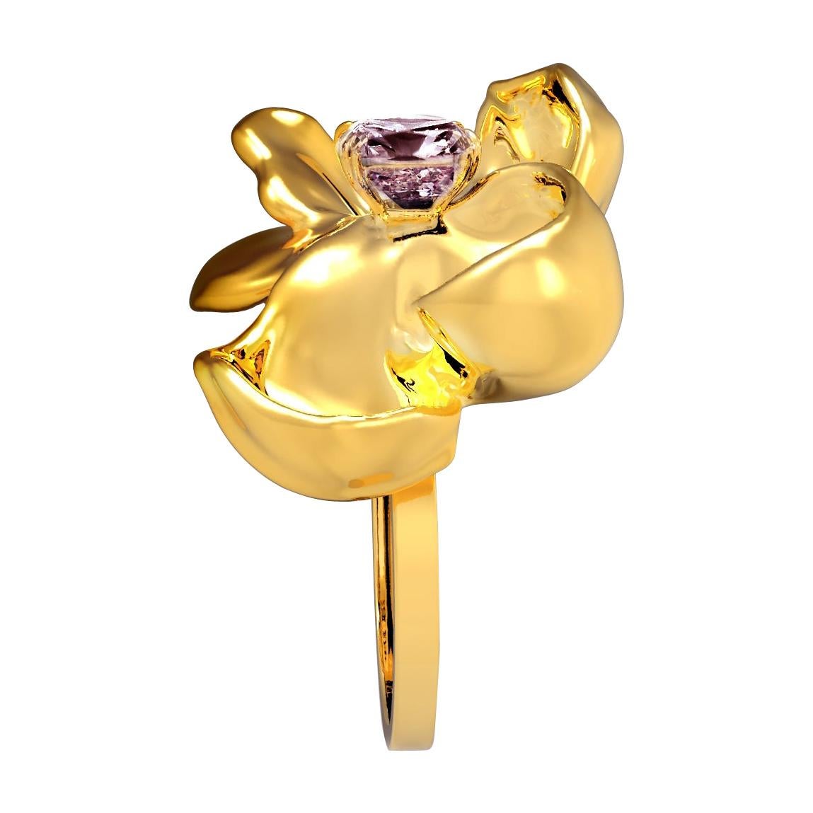 This contemporary Magnolia Flower cocktail ring is crafted in 18 karat yellow gold and features a stunning berry purple cushion spinel weighing 1.7 carats. The water-surface of the spinel amplifies the light, creating a stunning reflection on the