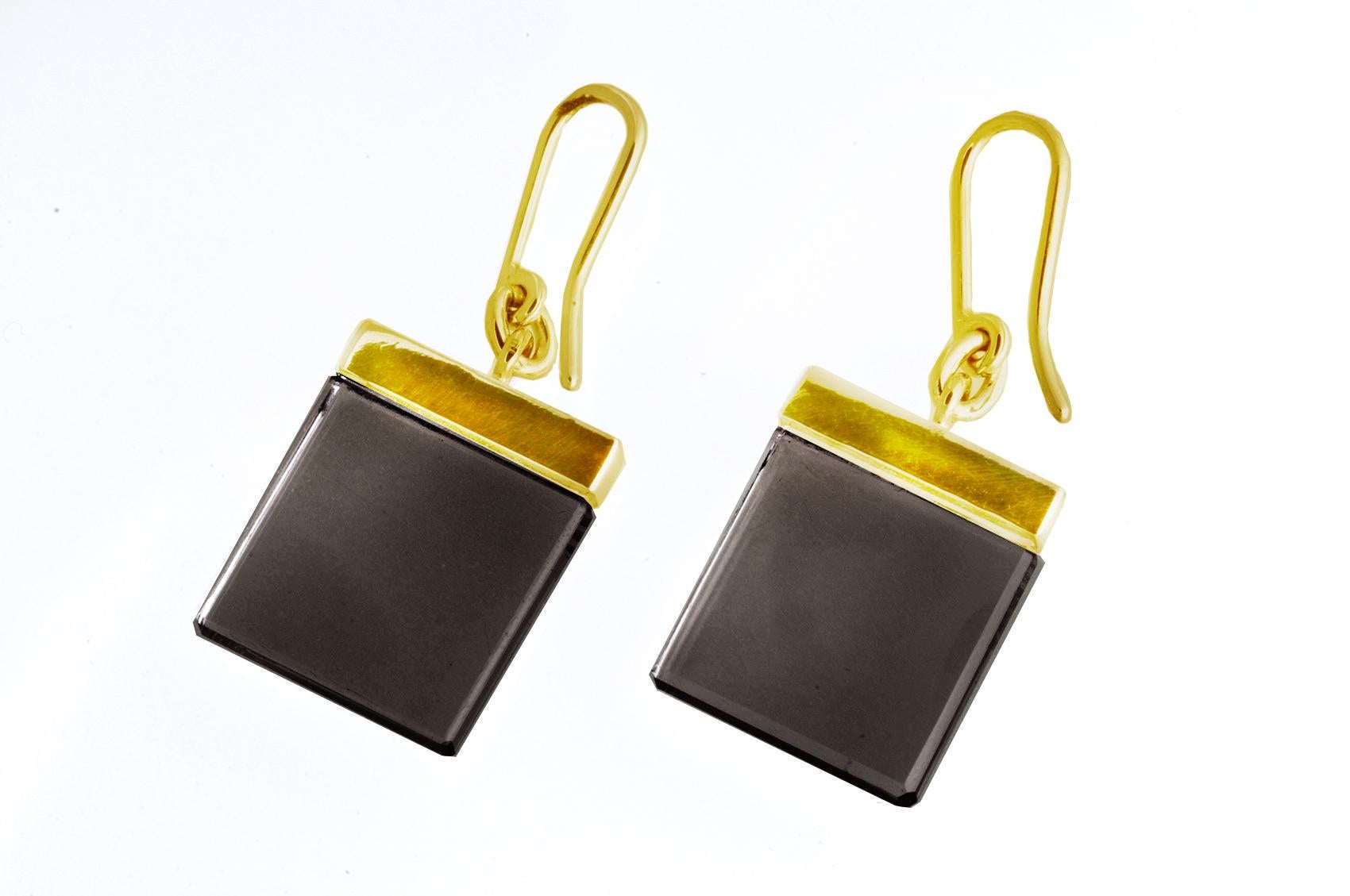 This contemporary jewelry collection was featured in Harper's Bazaar UA and Vogue UA published issues.

The earrings are made of 18 karat yellow gold and feature dark quartzes (morions) that measure 15x15x3 mm.

The Ink collection was designed by