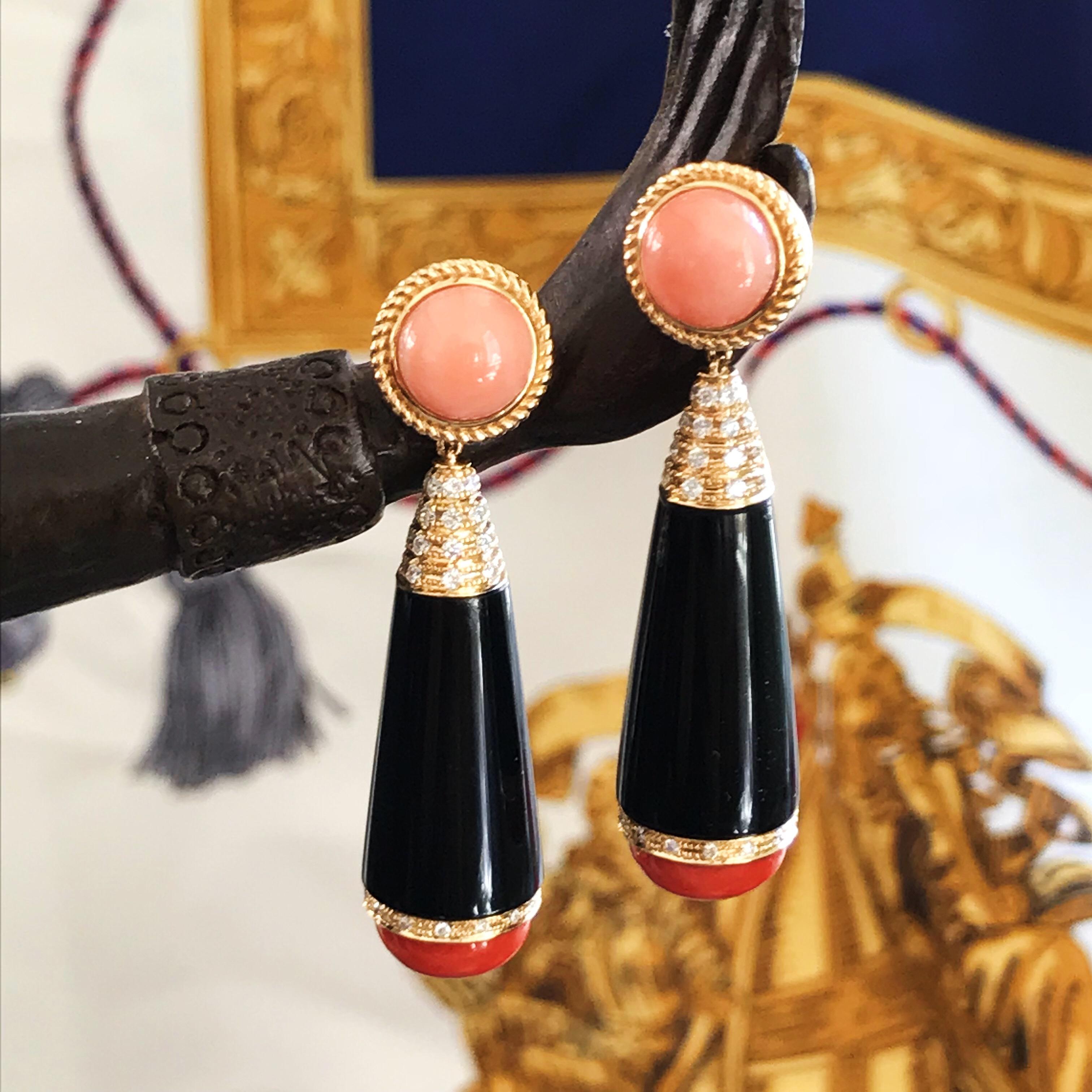 A beautiful 18ct Yellow Gold Coral and Onyx Drop Earrings. Design in Art Deco style using black onyx, coral and diamond combination. Top set with pink coral button, with Conical shape onyx drop with diamond set on top,  bottom part close up with a