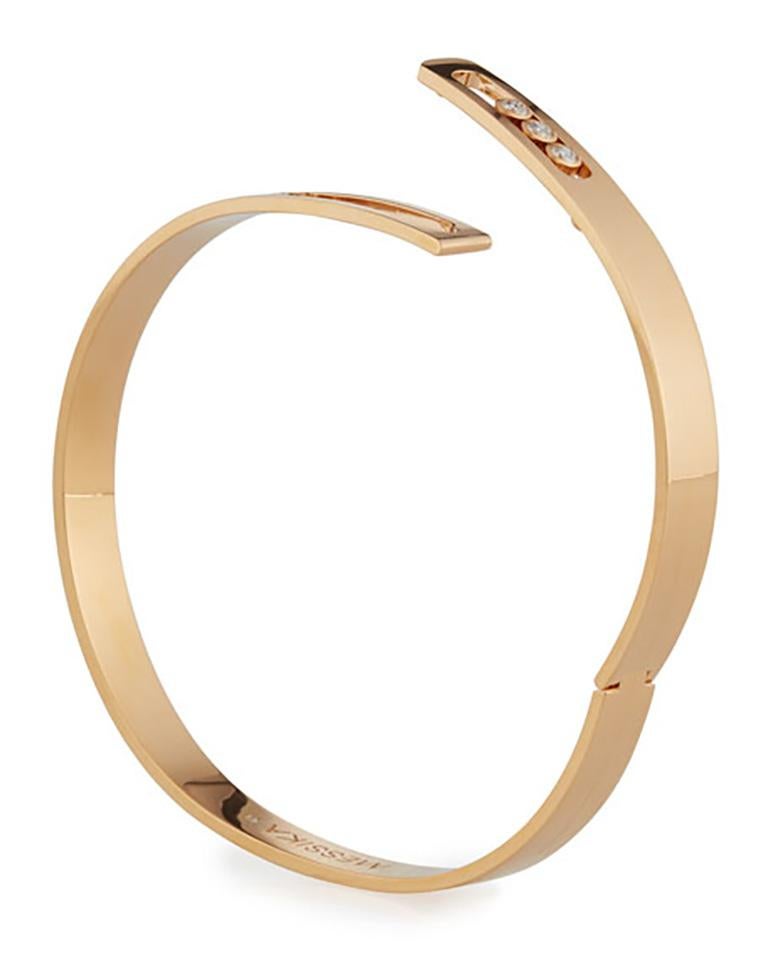 18kt yellow gold diamond cuff bracelet by the French brand Messika, this oval shaped bangle bracelet is from the Move Collection. The hinged clasp on the handmade gold band is perfectly integrated into the design, a technique only mastered by the