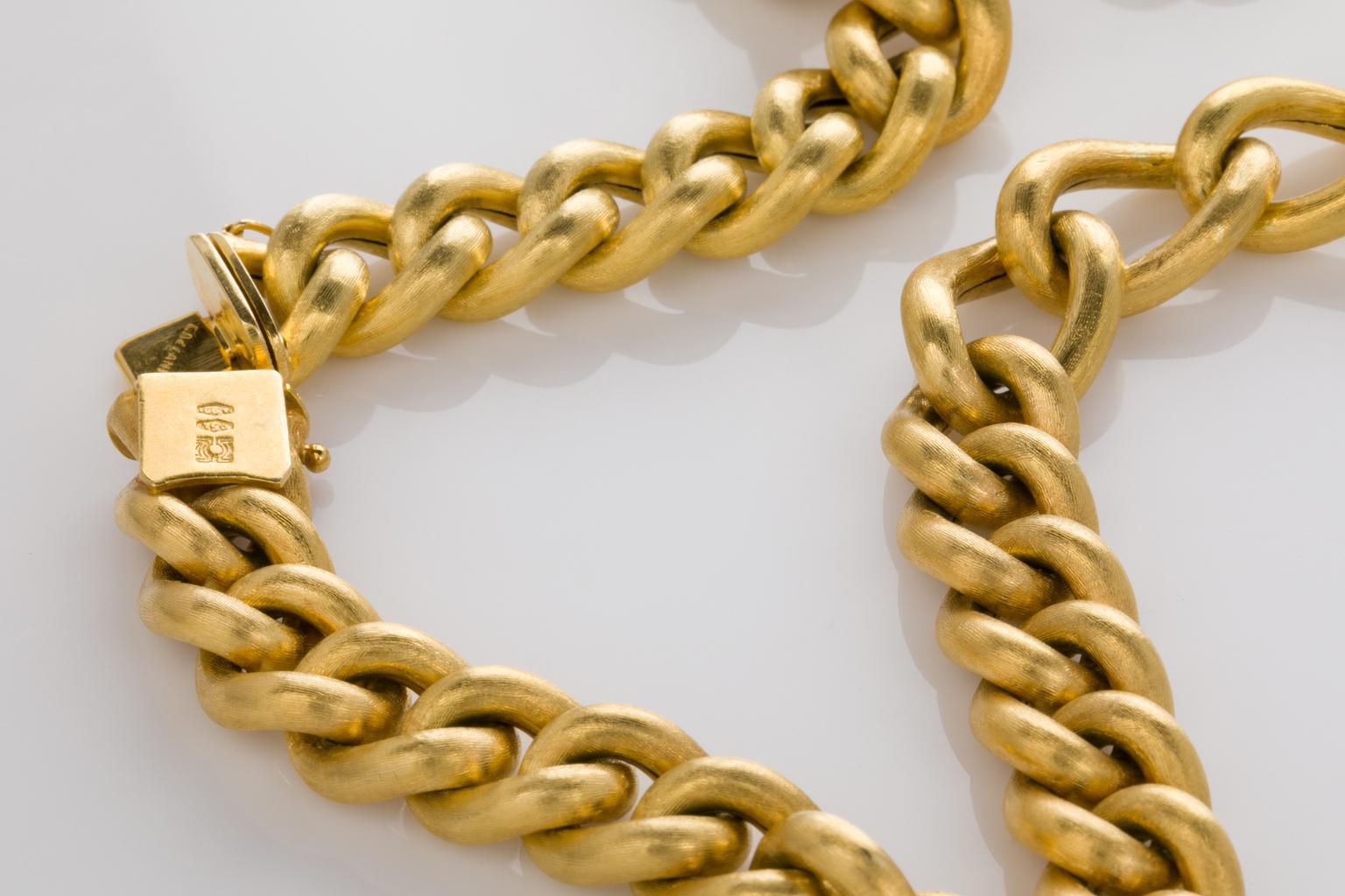 A fabulous gold link chain necklace with a combination of shorter and longer curb links. It's a big and bold look on the neckline and can be worn layered with other chains. Each link has a subtle brushed/satin look showing wonderful craftsmanship.