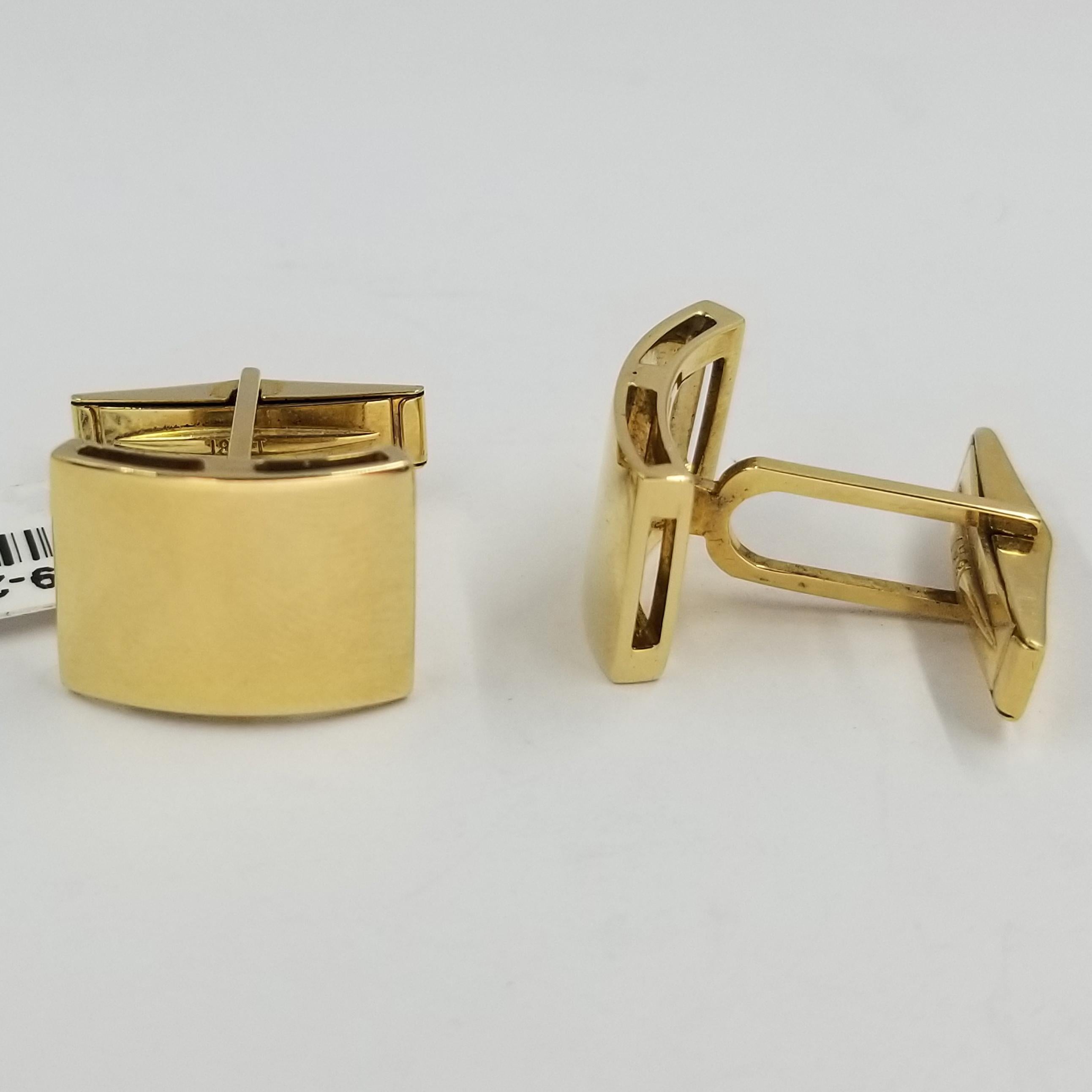 Set of 2 cufflinks crafted in 18 karat yellow gold (stamped). The fronts are polished and curve outward. The backs are a hinged torpedo style for easy dressing.