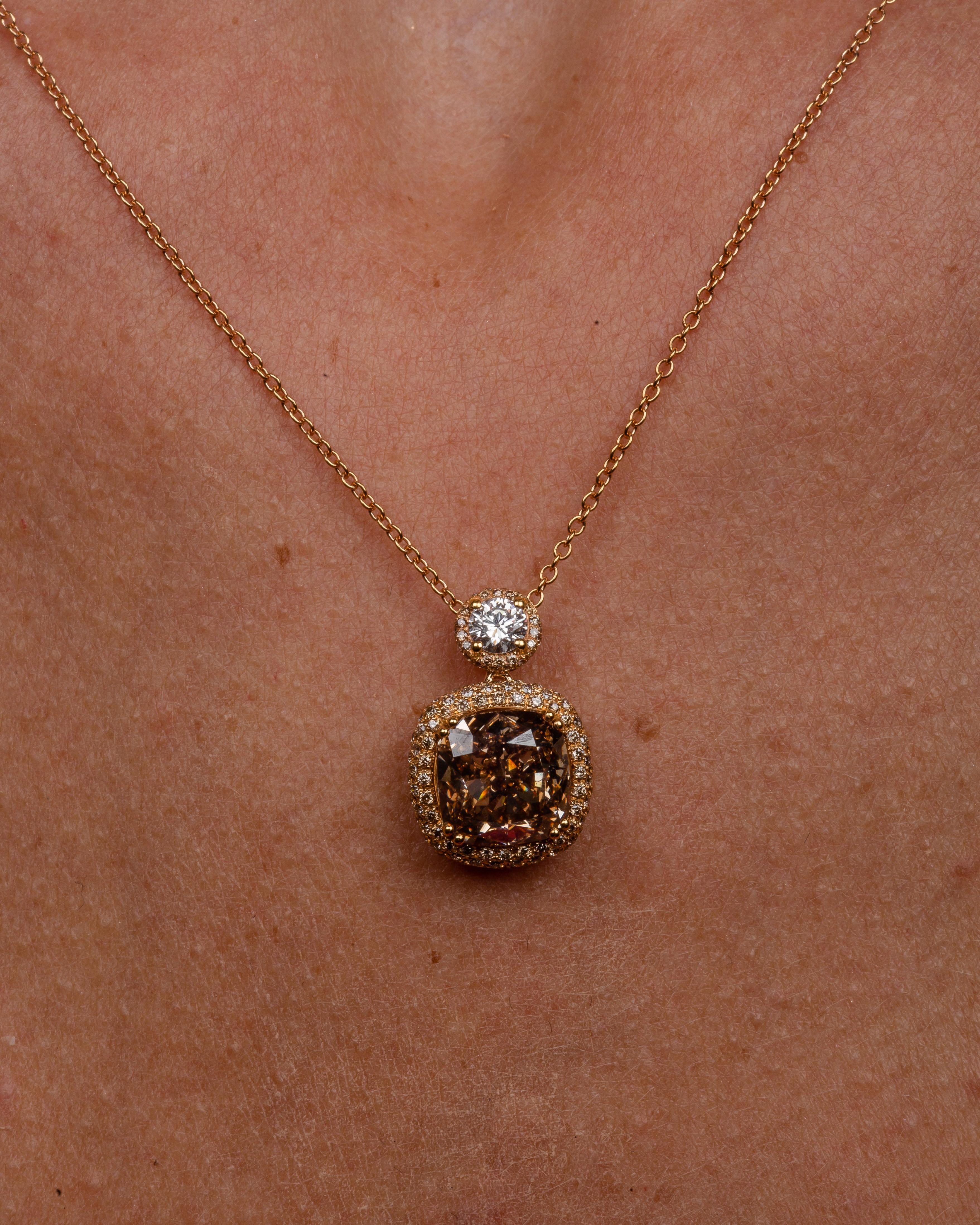This 18K yellow gold elegant pendant is from our Divine Collection. It is made of an cushion cut brown diamond in total of 4.16 Carat and round shape colourless diamond in total of 0.25 Carat.  Both diamonds are decorated by round brown diamonds in