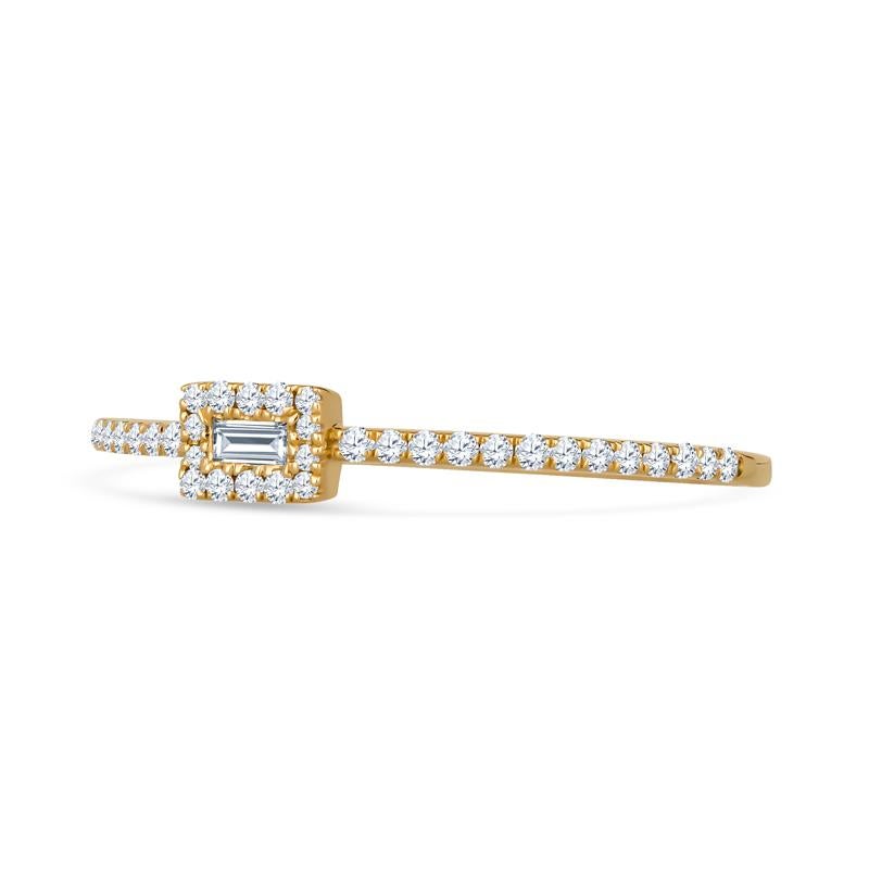 This dainty and fun ring features a small baguette diamond accented by a halo of round diamonds and diamonds on the band. This is a great stacking ring! It is set in 18 karat yellow gold and is a size 6.5 but can be resized upon