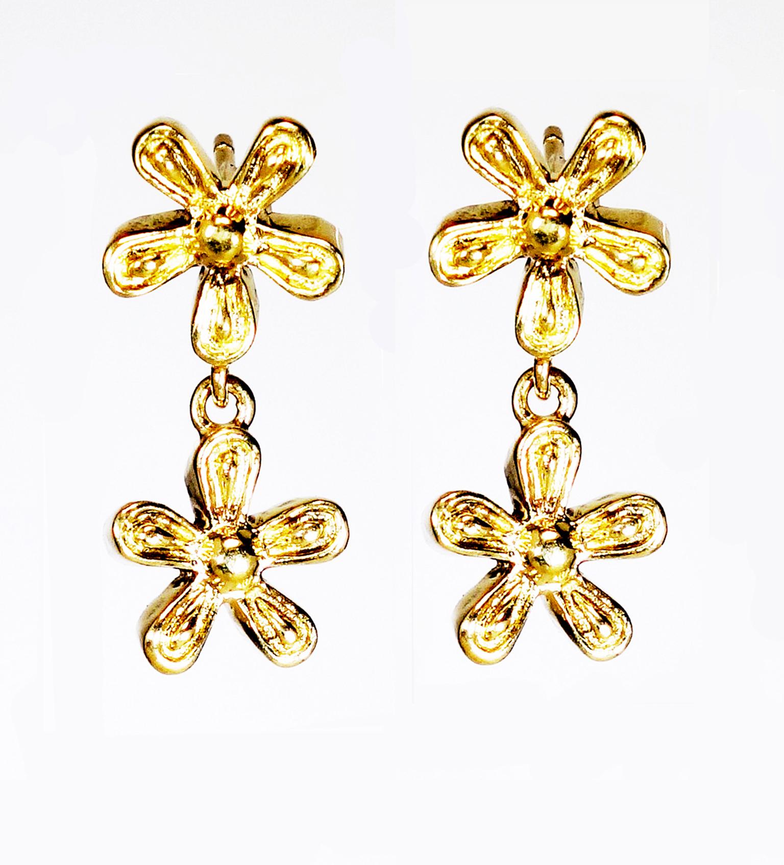 Flower power, A lovely 18  Karat Yellow Gold daisy earring for everyday wear. Finished: Polished
Dimension: Exterior Diameter measured; x 9 mm, H x 2.8 mm, Total length x 21 mm
* A post back closure is in 14 Karat Gold for durability. 

Collection