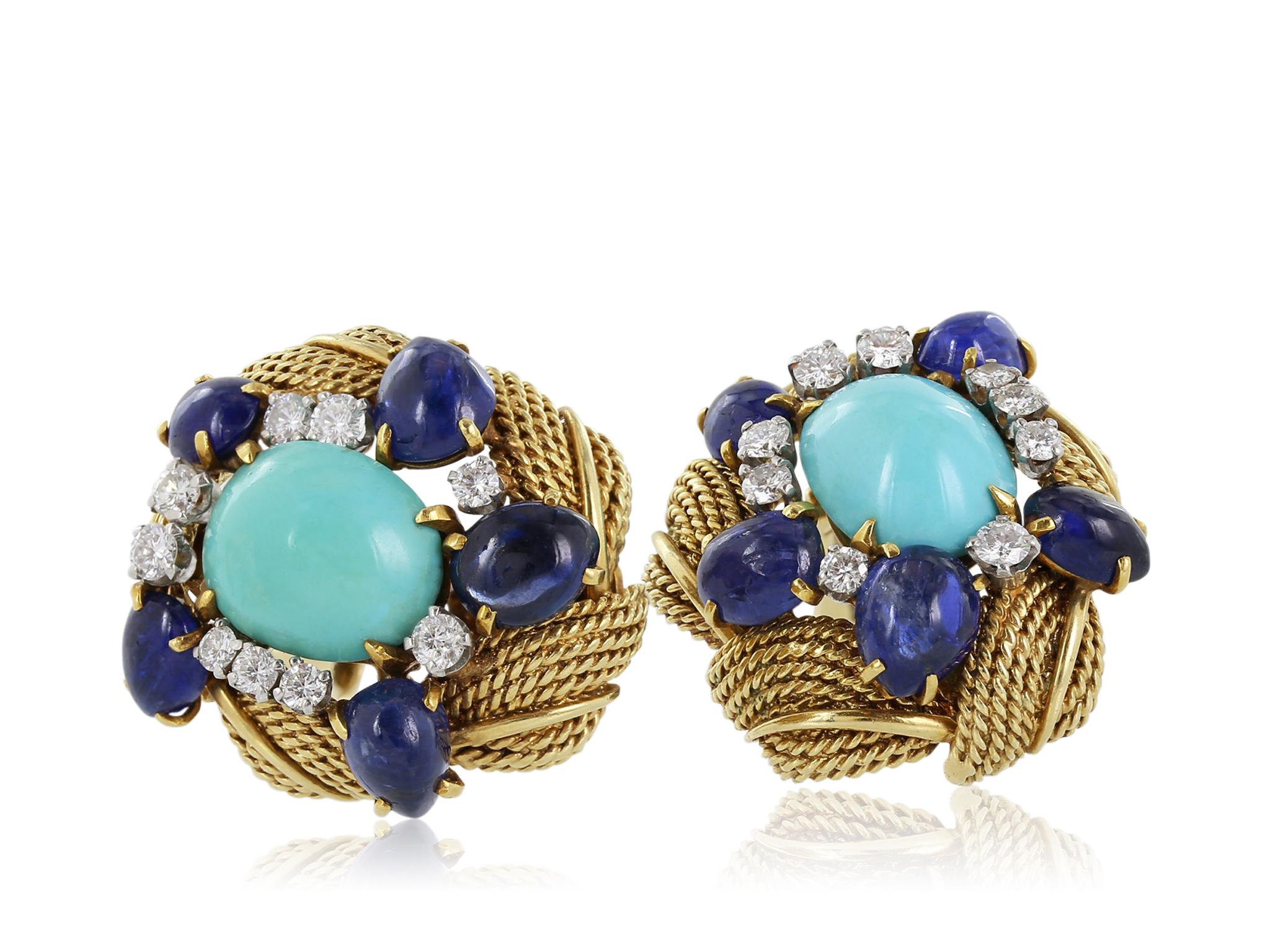 18 karat yellow gold earrings featuring 2 cabochon turquoise stones with an approximate weight of 8.80 carats surrounded by 18 full cut diamonds with an approximate weight of .90 carats alternating with 10 cabochon sapphires with an approximate