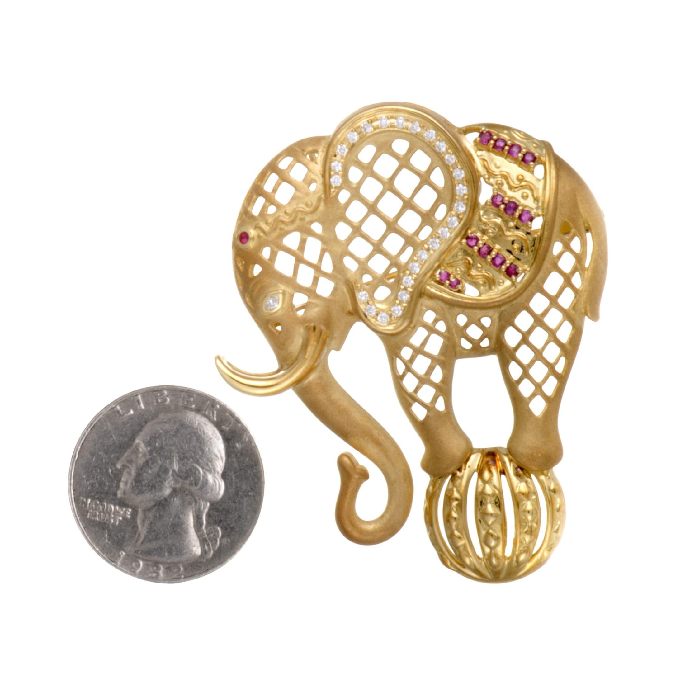 Taking the form of an elephant in a splendidly lustrous fashion, this exceptional 18K yellow gold brooch boasts an incredibly attractive appeal. The brooch is set with diamonds that weigh 0.41 carats in total and with rubies that amount to 0.29