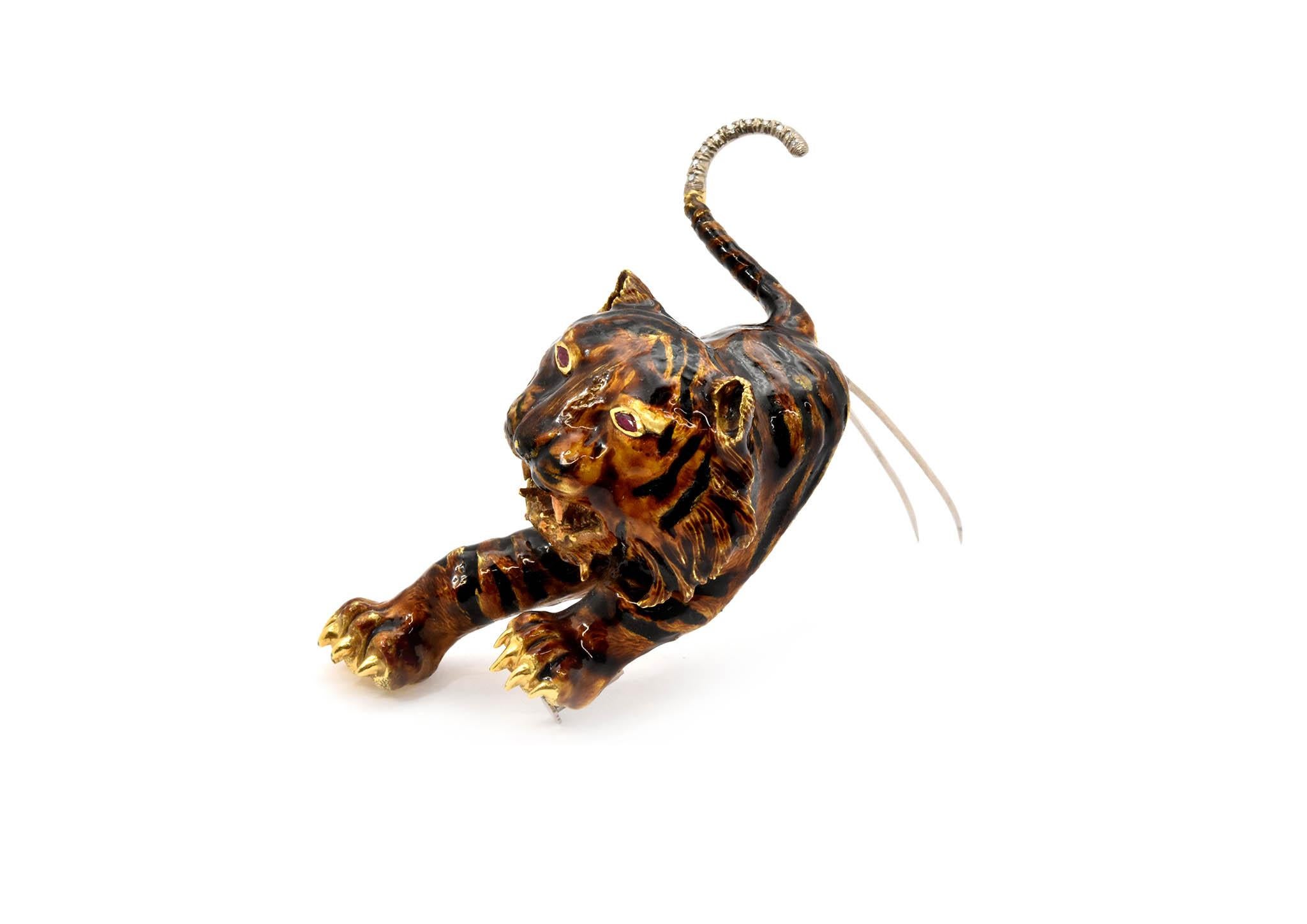 This one of a kind piece is crafted in 18k yellow gold. It resembles a tiger and is designed with black and gold enamel. Two marquise cut rubies are set as the tiger’s eyes. In addition, the tiger’s tail is set with ten round singe-cut diamonds,