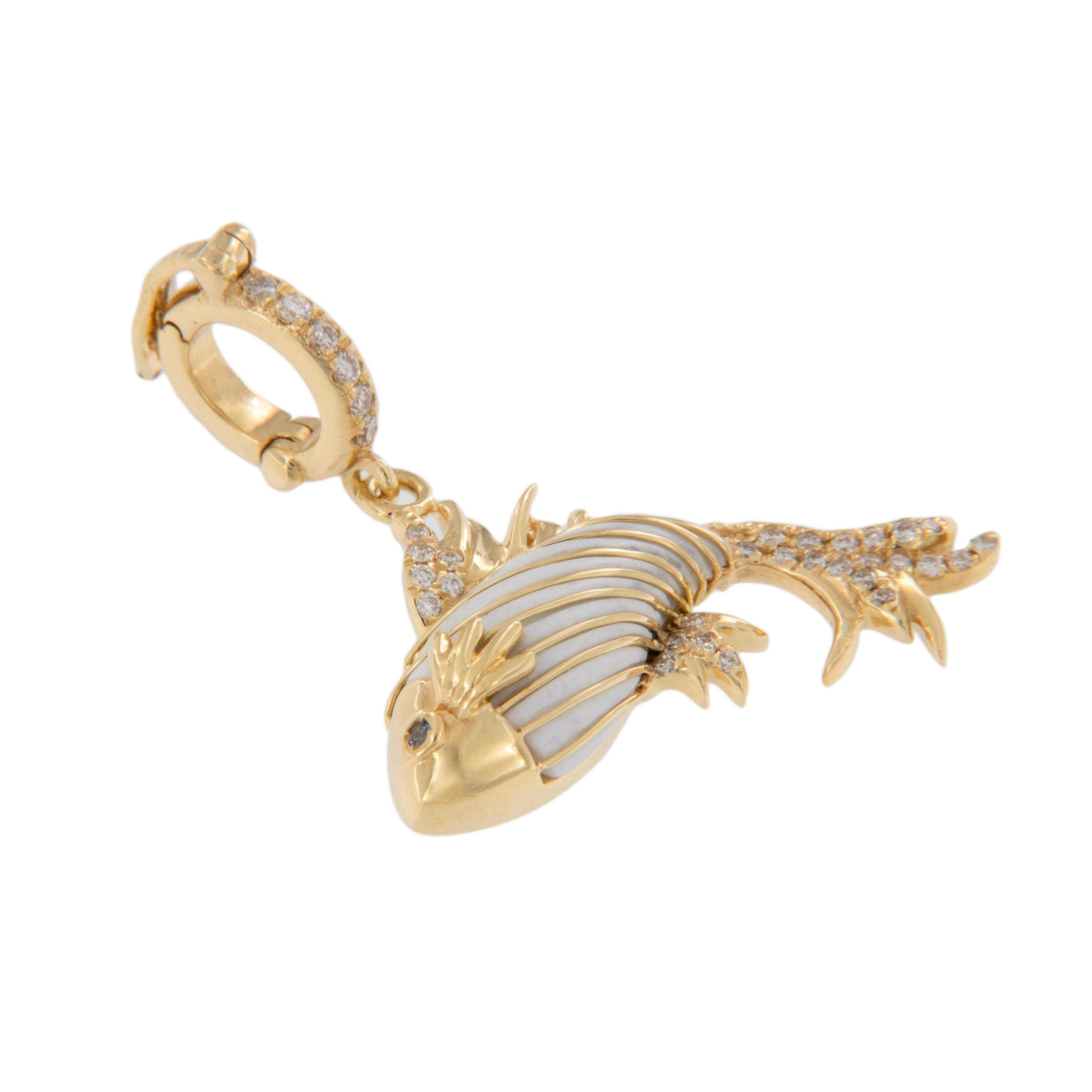 Crafted in rich 18 karat yellow gold this elegant Pisces fish is accented with white onyx & white diamonds = 0.11 Cttw. for a striking and fluid look! White diamonds accent the bail which is hinged making it easy to wear with your favorite chain or