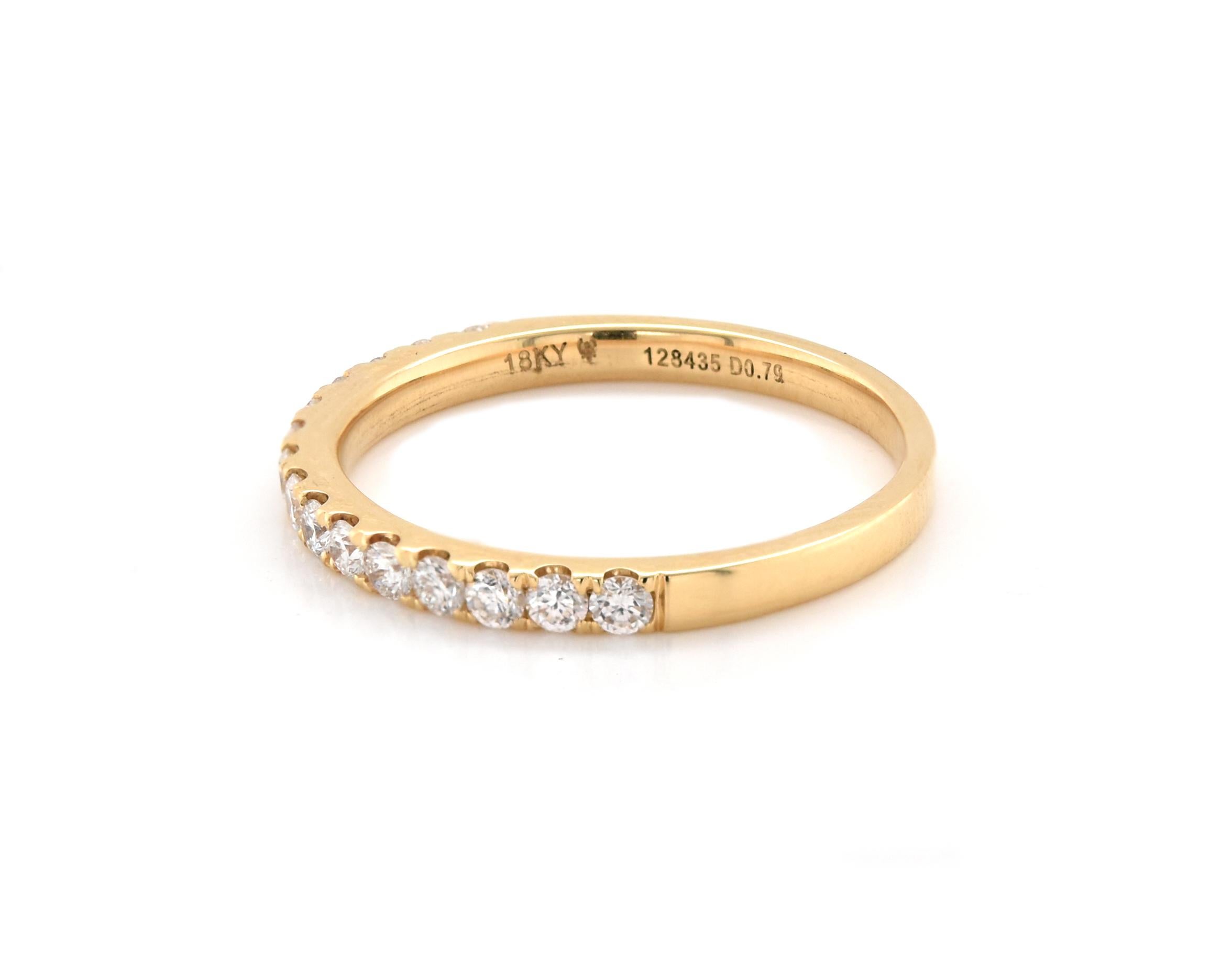 Designer: custom
Material: 18k yellow gold
Diamonds: 15 round cut = .45cttw
Color: G
Clarity: VS1
Size: 7 (please allow two additional shipping days for sizing requests)  
Dimensions: ring measures 2.04mm in width
Weight: 2.10 grams
