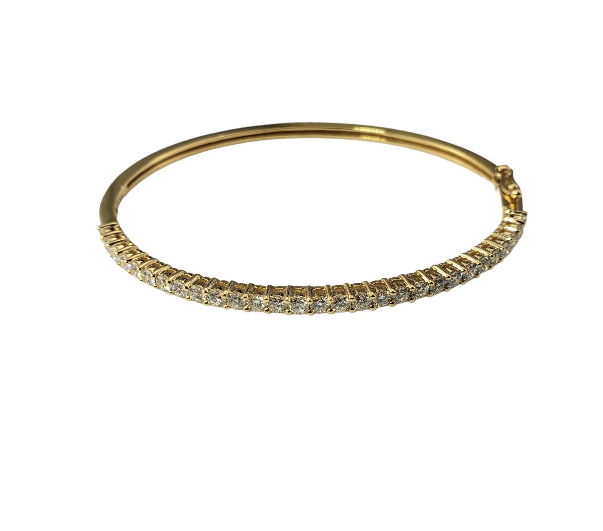 18 Karat Yellow Gold Diamond Bangle Bracelet-

This sparkling bangle bracelet features 29 round brilliant cut diamonds set in classic 18K gold.  Hinged closure.  

Width: 2.6 mm.

Approximate total diamond weight: 1.74 ct.

Diamond color: G

Diamond