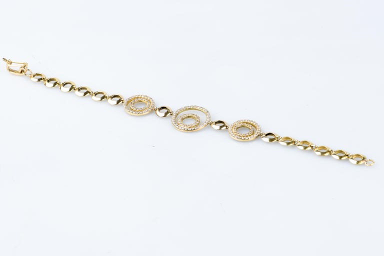 Women's 18 karat yellow gold diamond bracelet designed with round brillant cut diamonds For Sale