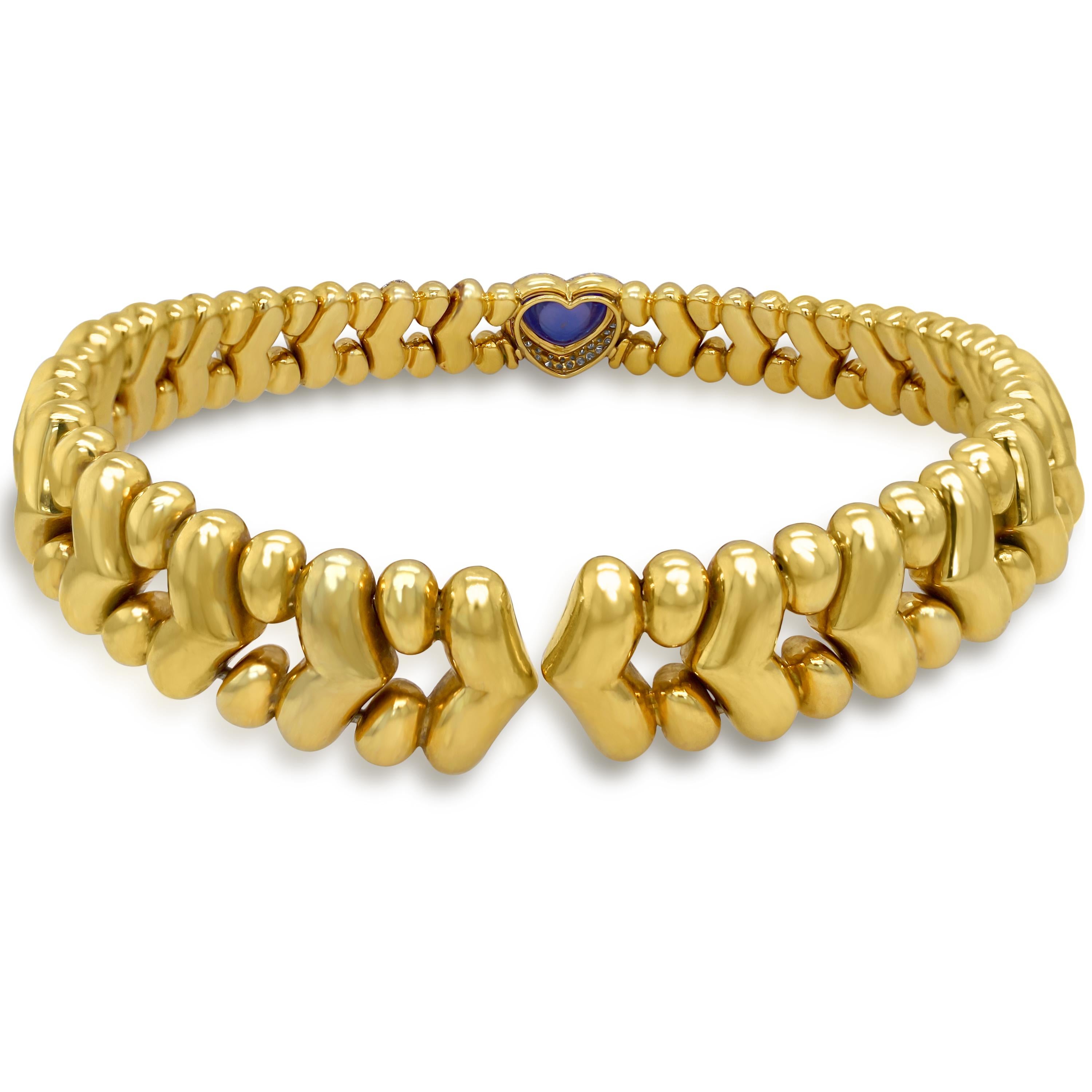 18 Karat Yellow Gold Diamond Cabochon Heart Shape Blue Sapphire Choker Necklace by Faraone

This state-of-the-art choker style necklace features a solid 18k yellow gold design with two sections of diamonds on the left and right side. The center is