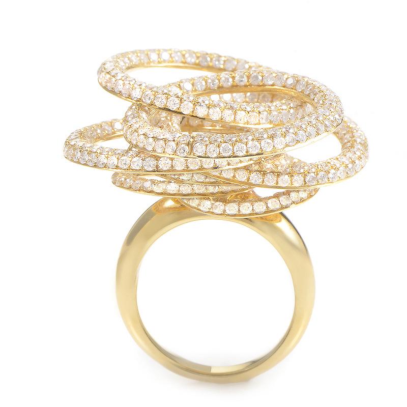 A whirlwind of diamonds take center stage in the design of this lavish cocktail ring. The ring is made of 18K yellow gold and features overlapping circle motifs set with diamonds.