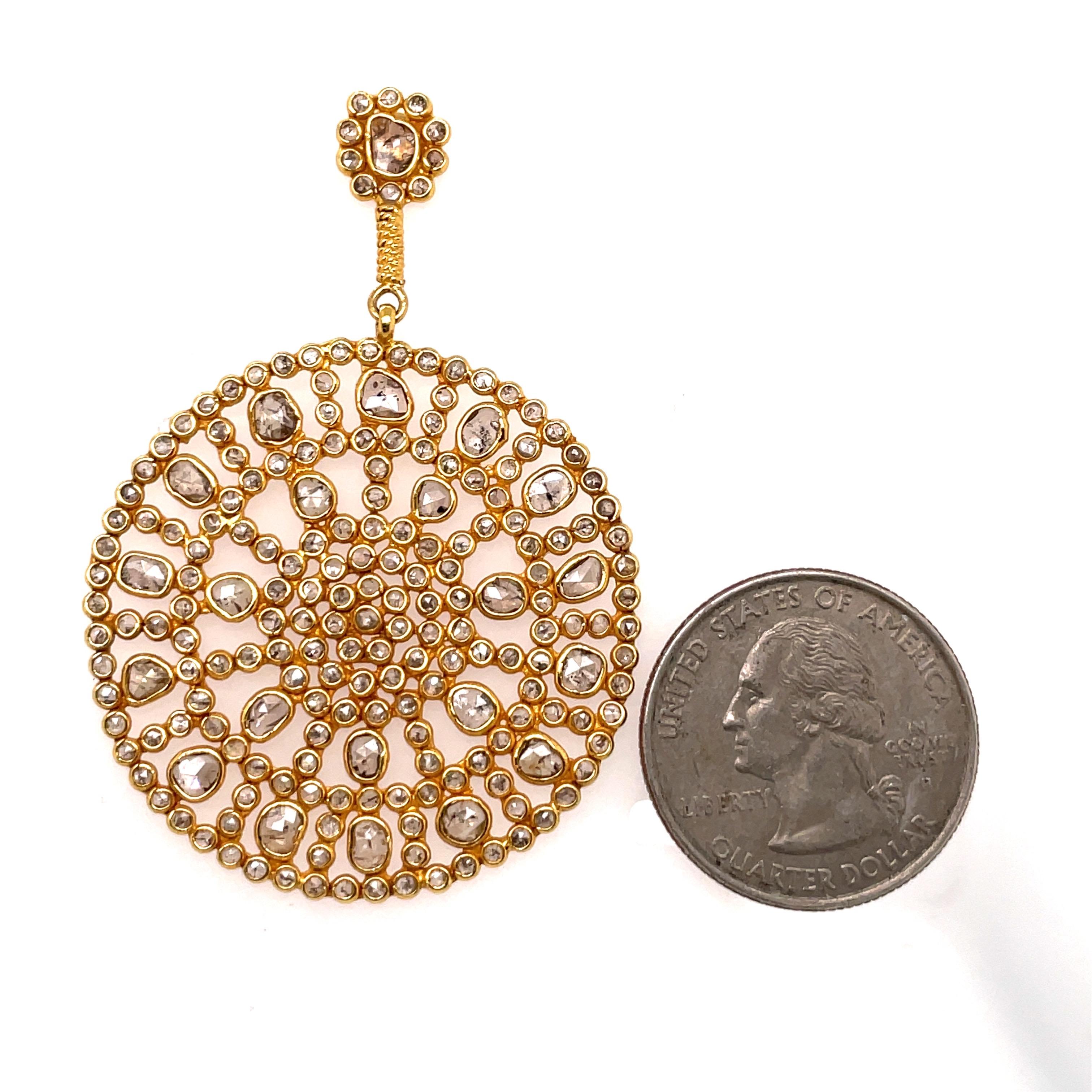 18 Karat yellow gold drop disc earrings featuring numerous sliced diamonds weighing approximately 11 carats.
Very fashionable!  