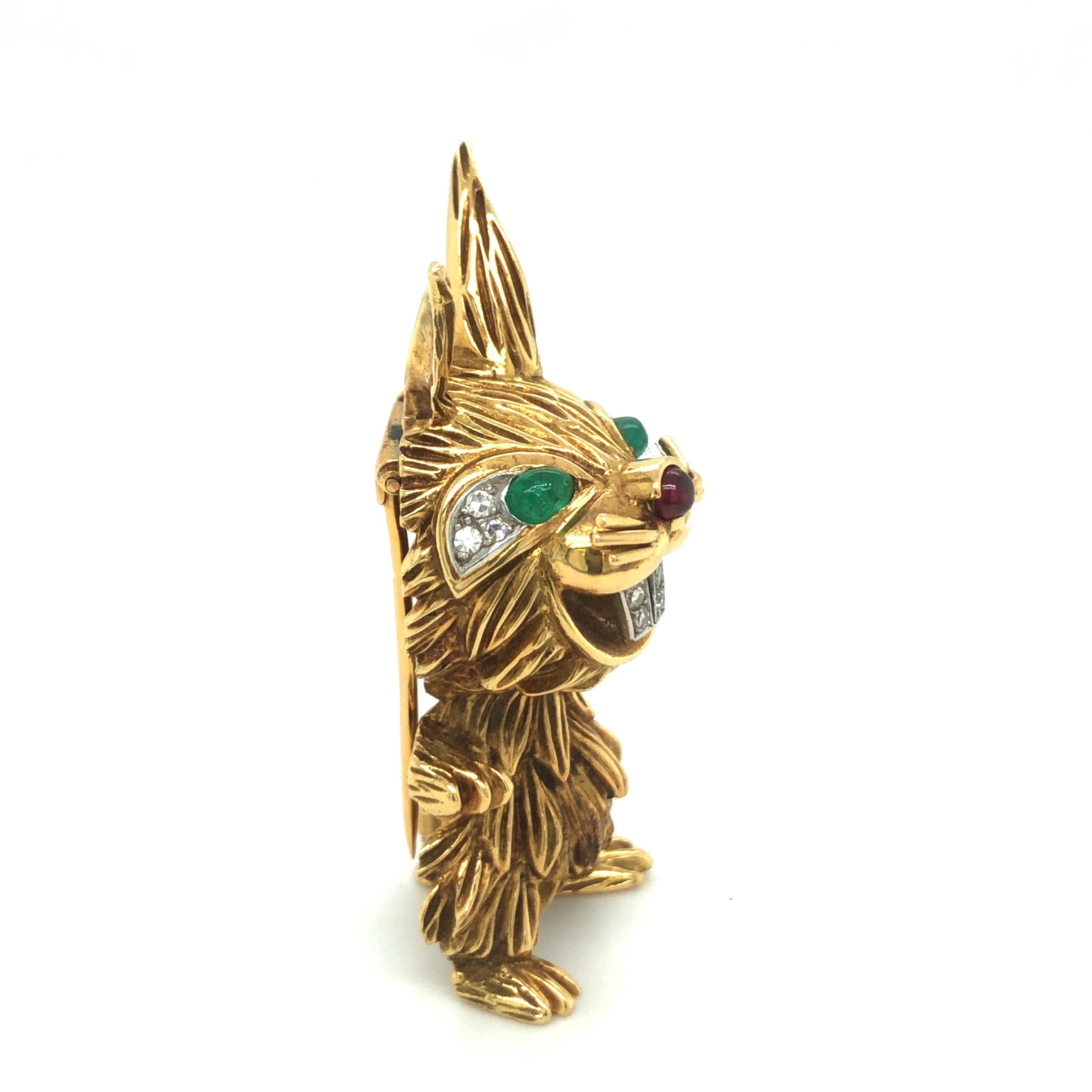 Hilarious 18 karat yellow gold single-cut diamond emerald ruby rabbit brooch of French provenance, circa 1960s.
Depicting a cheerful standing rabbit with head and body crafted in high relief, tousled fur and lop-ears, emerald and pavé-set diamond