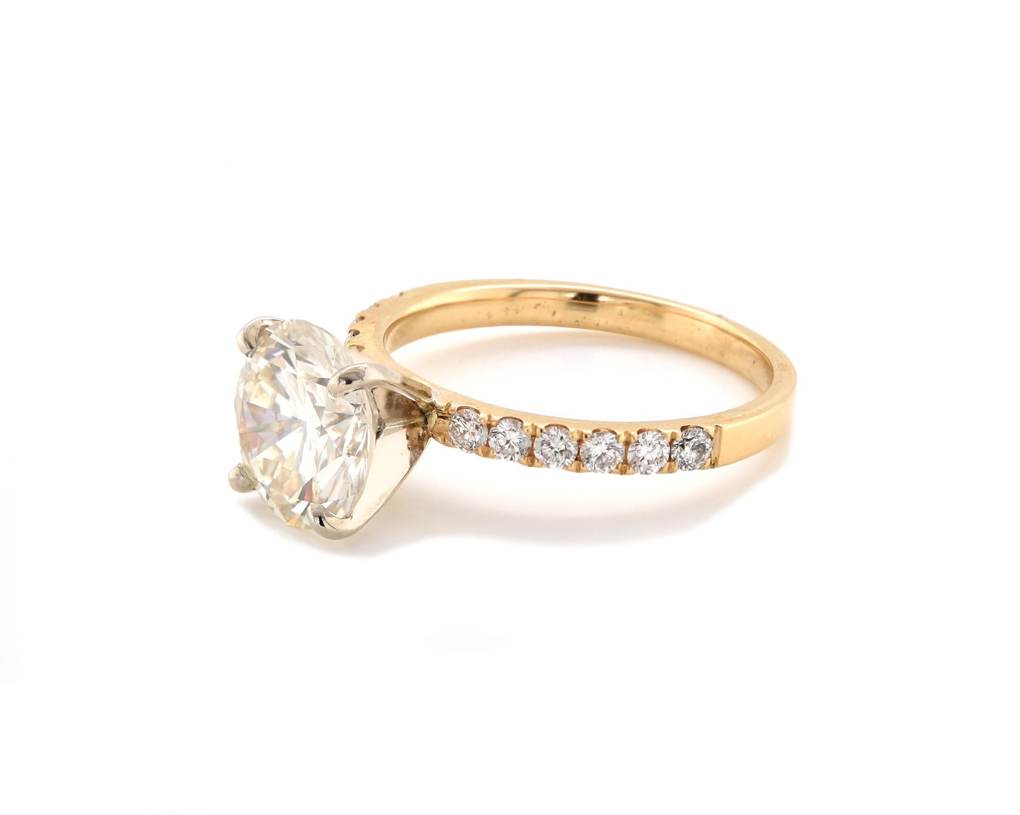 Designer: custom
Material: 18K yellow gold
Diamond: 1 round brilliant cut = 2.83ct
Color: L
Clarity: SI1
Diamonds: 12 round cut = .36cttw
Color: G
Clarity: VS2
Ring Size: 7 (please allow up to 2 additional business days for sizing