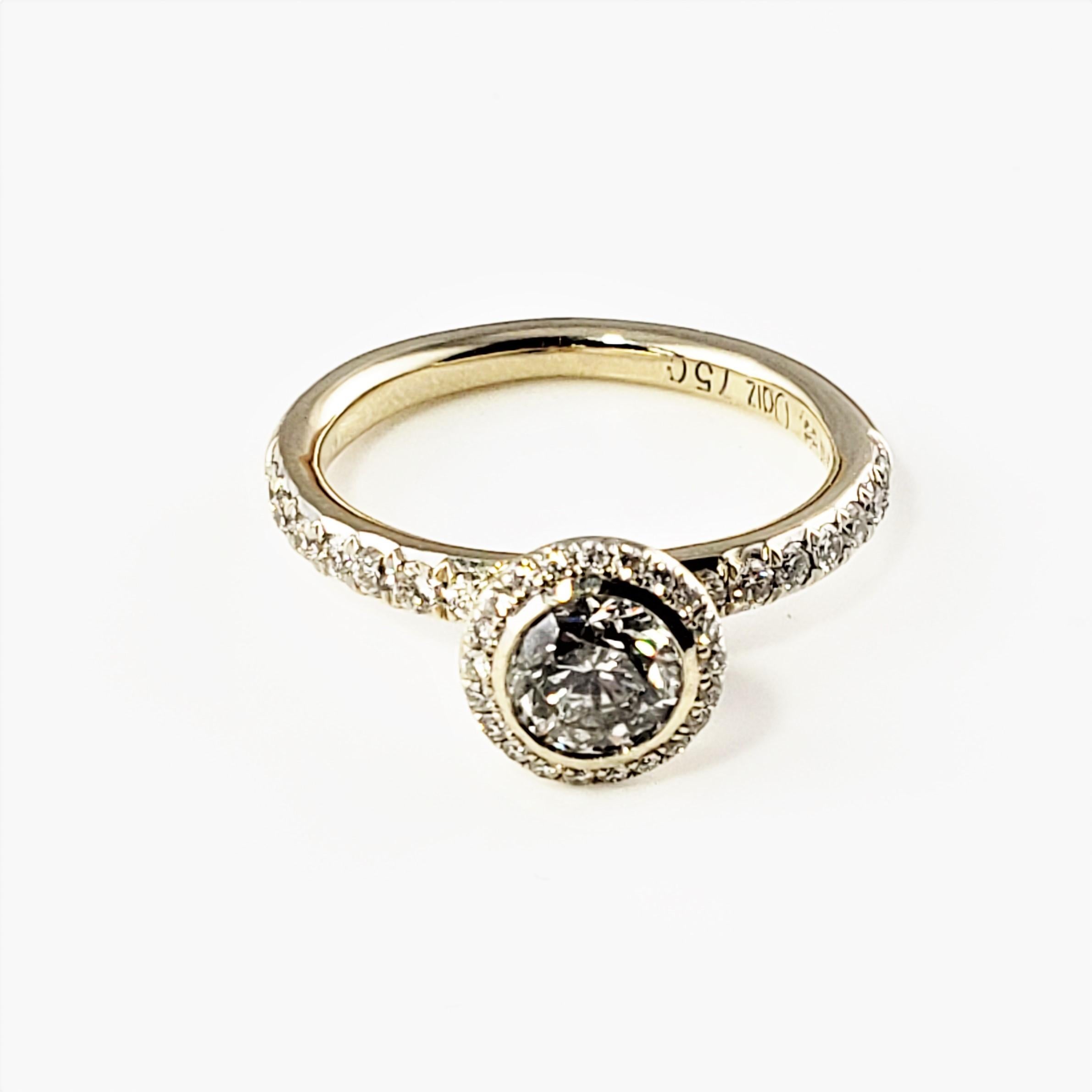 18 Karat Yellow Gold Diamond Engagement Ring Size 6-

This dazzling ring features one round brilliant cut diamond in its center (.65 ct.) and 36 round brilliant cut diamonds on the surrounding halo and band.  Top of ring measures 8 mm.  Height:  8