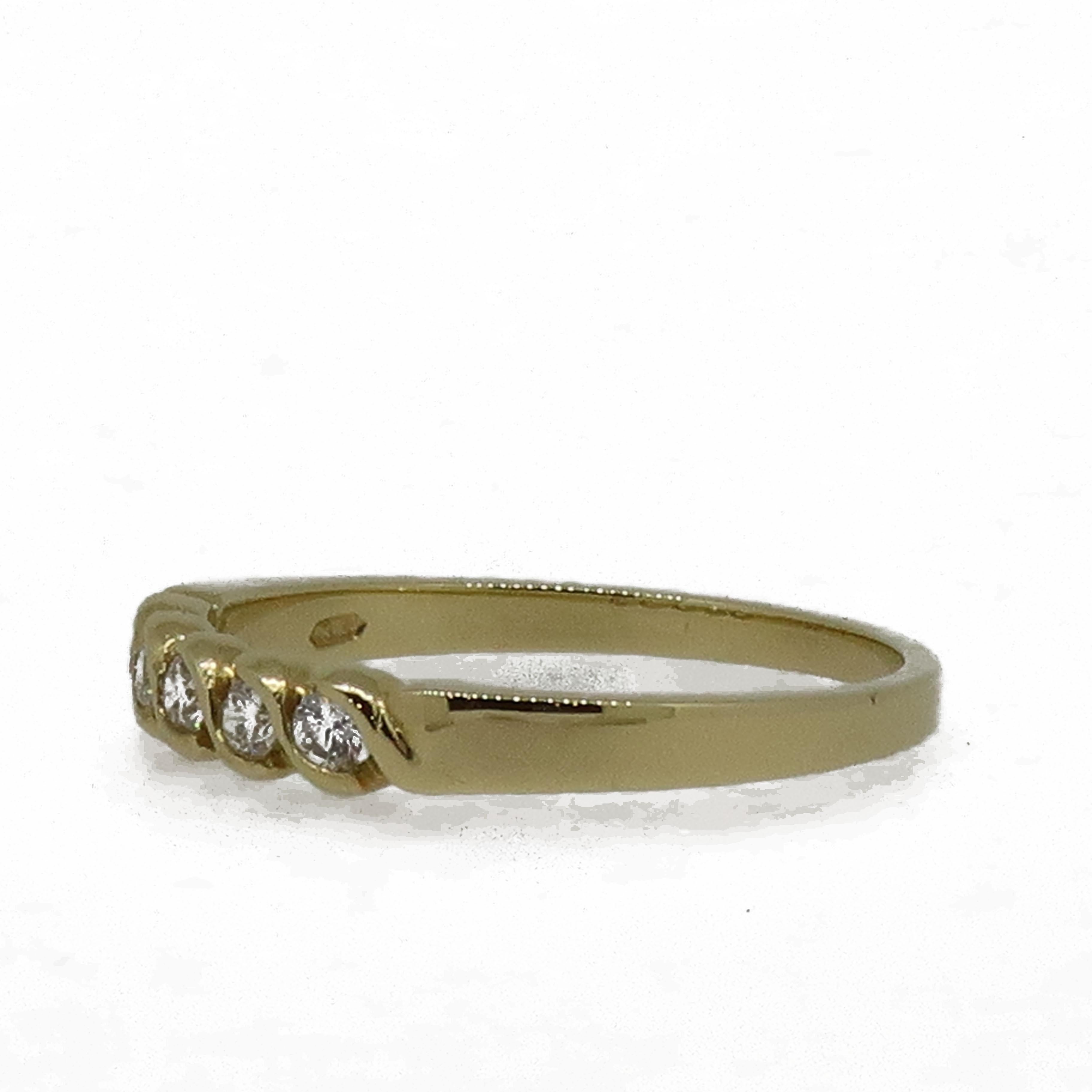 18 Karat Yellow Gold Diamond Eternity Band Ring

A delicate diamond eternity ring. Consisting of five white brilliant cut diamonds, weighing 0.16ct in total. The diamonds are set in a rub over S style setting.
It would make the perfect wedding band