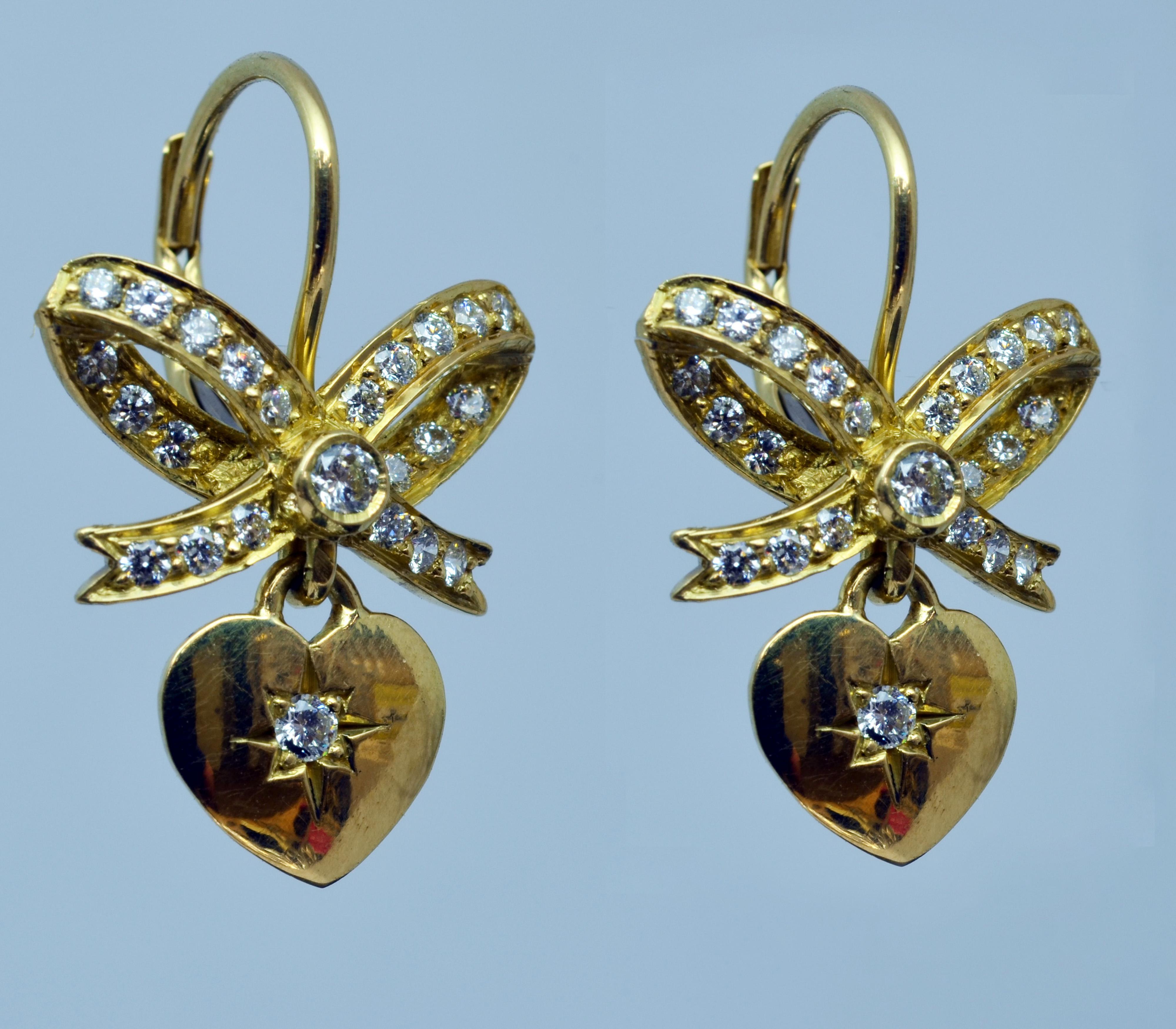 Artisan 18 Karat Yellow Gold Diamond Heart and Bow Dangle Lever Back Earrings For Sale