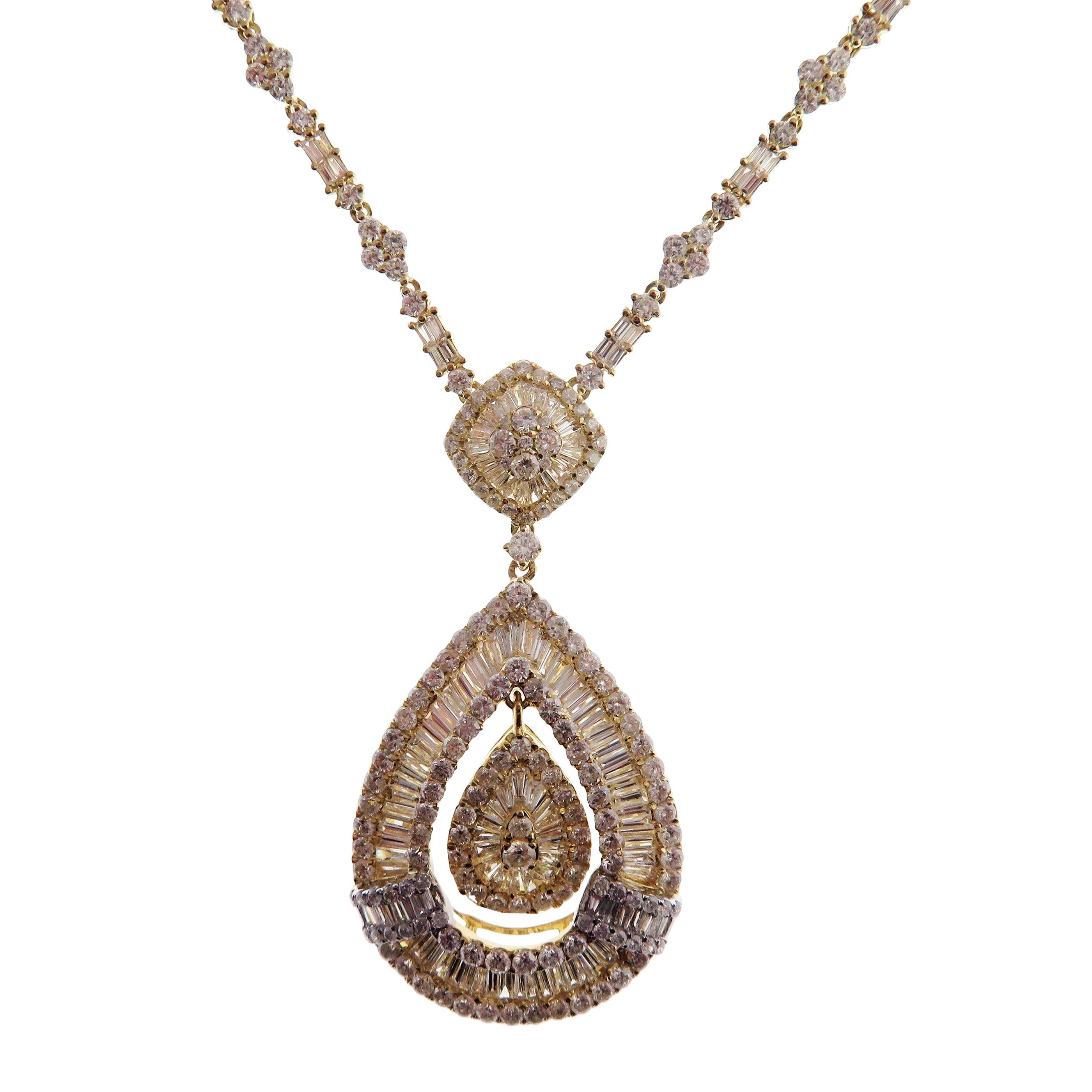 This modern pear baguette necklace is crafted in 18-karat yellow gold, weighing approximately 9.22 total carats of V Quality white diamond. These are very comfortable, flexible, and lay flat. We have these in matching earrings as well. 

Necklace is