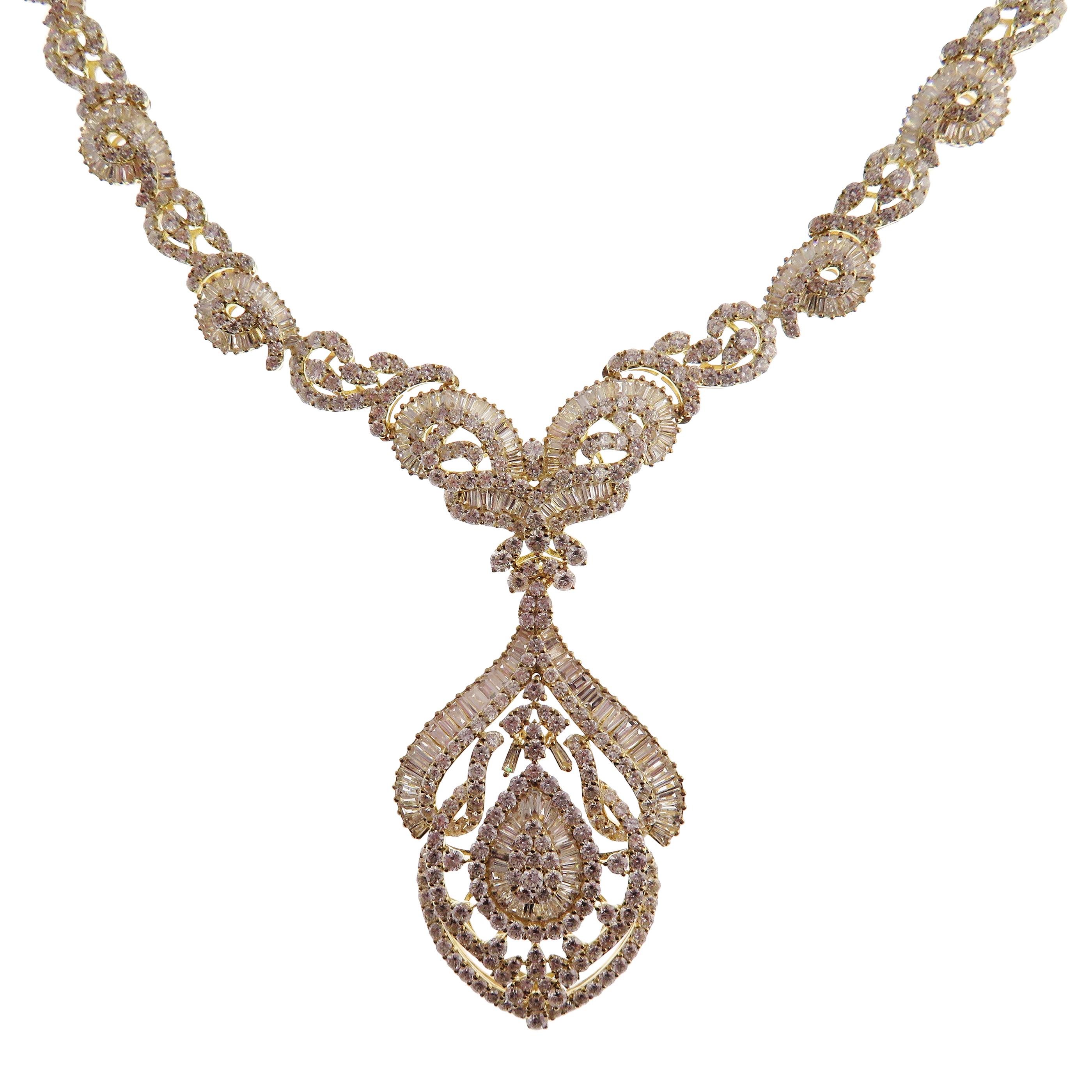 This chandelier baguette necklace is crafted in 18-karat yellow gold, weighing approximately 18.12 total carats of V Quality white diamond. These are very comfortable, flexible, and lay flat. We have these in matching earrings as well. 

Necklace is