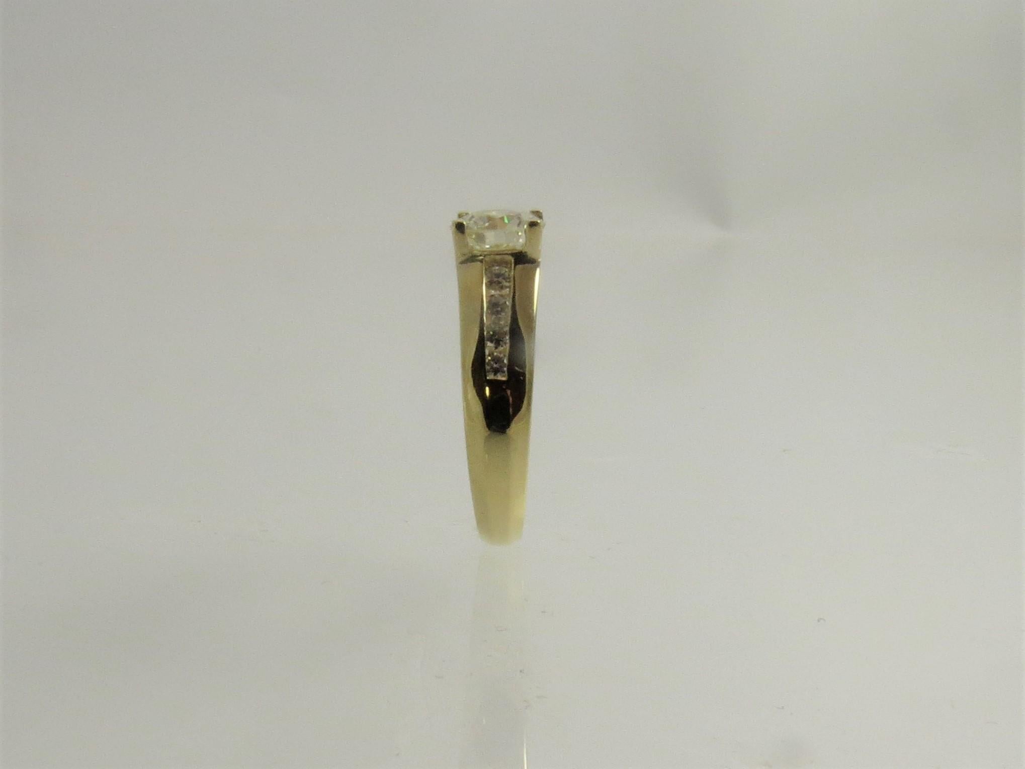 18K yellow gold ring by Kurt Wayne, channel set with 9 full cut round diamonds, weighing 1.45cts, G color, VS1 clarity
Finger size, may be sized
Retail $3300