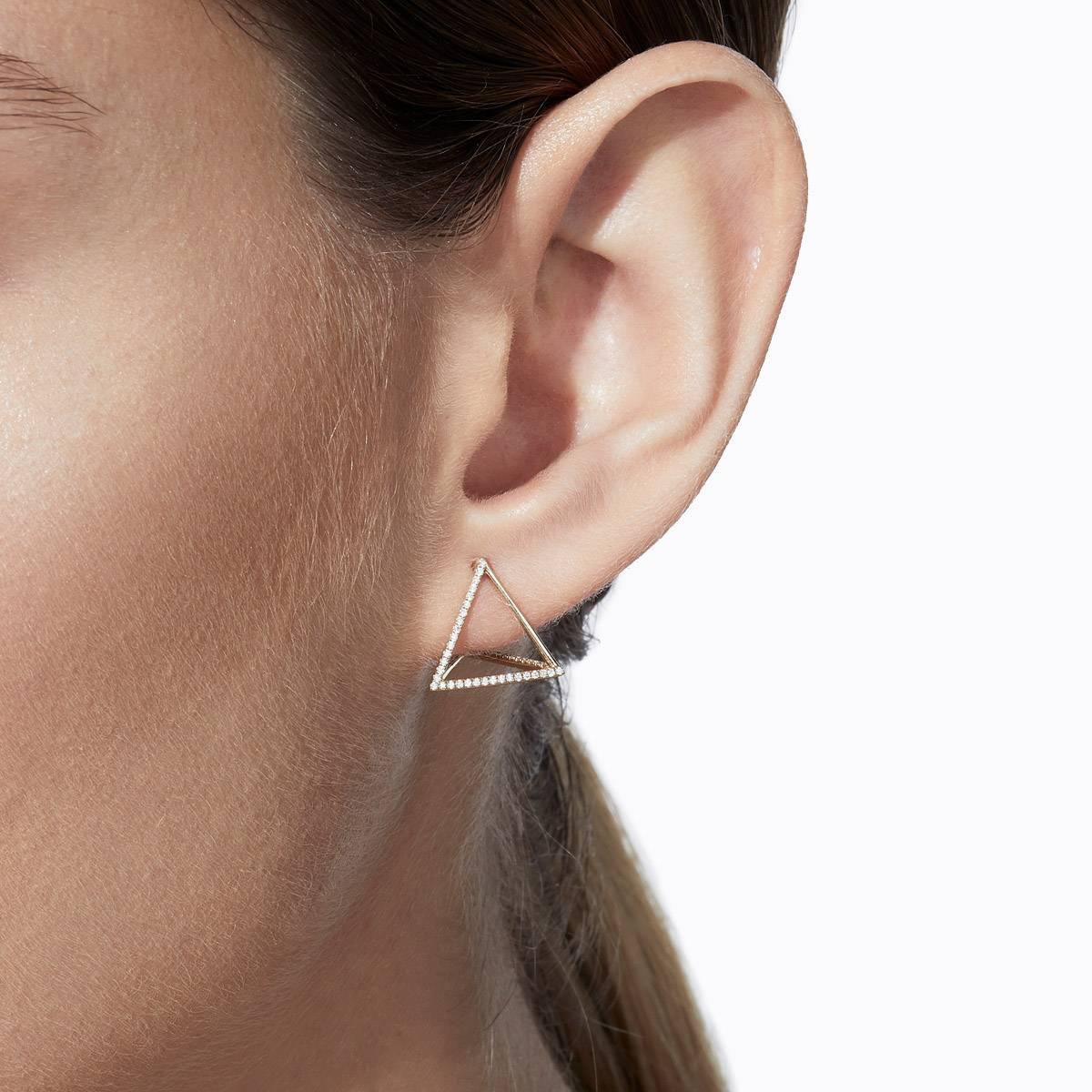 The three dimensional triangle form appears to float seamlessly around the earlobe when worn. One side is an earring post and three lines are set with micro diamonds creating a subtle but luxurious effect. You can alter the point at which the