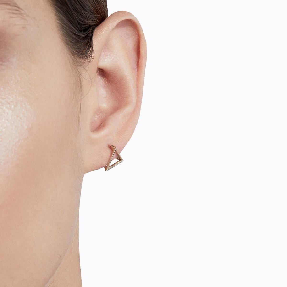 The three dimensional triangle form appears to float seamlessly around the earlobe when worn. Also suitable for cartilage piercings. One side is an earring post and three lines are set with micro diamonds creating a subtle but luxurious effect. 

18