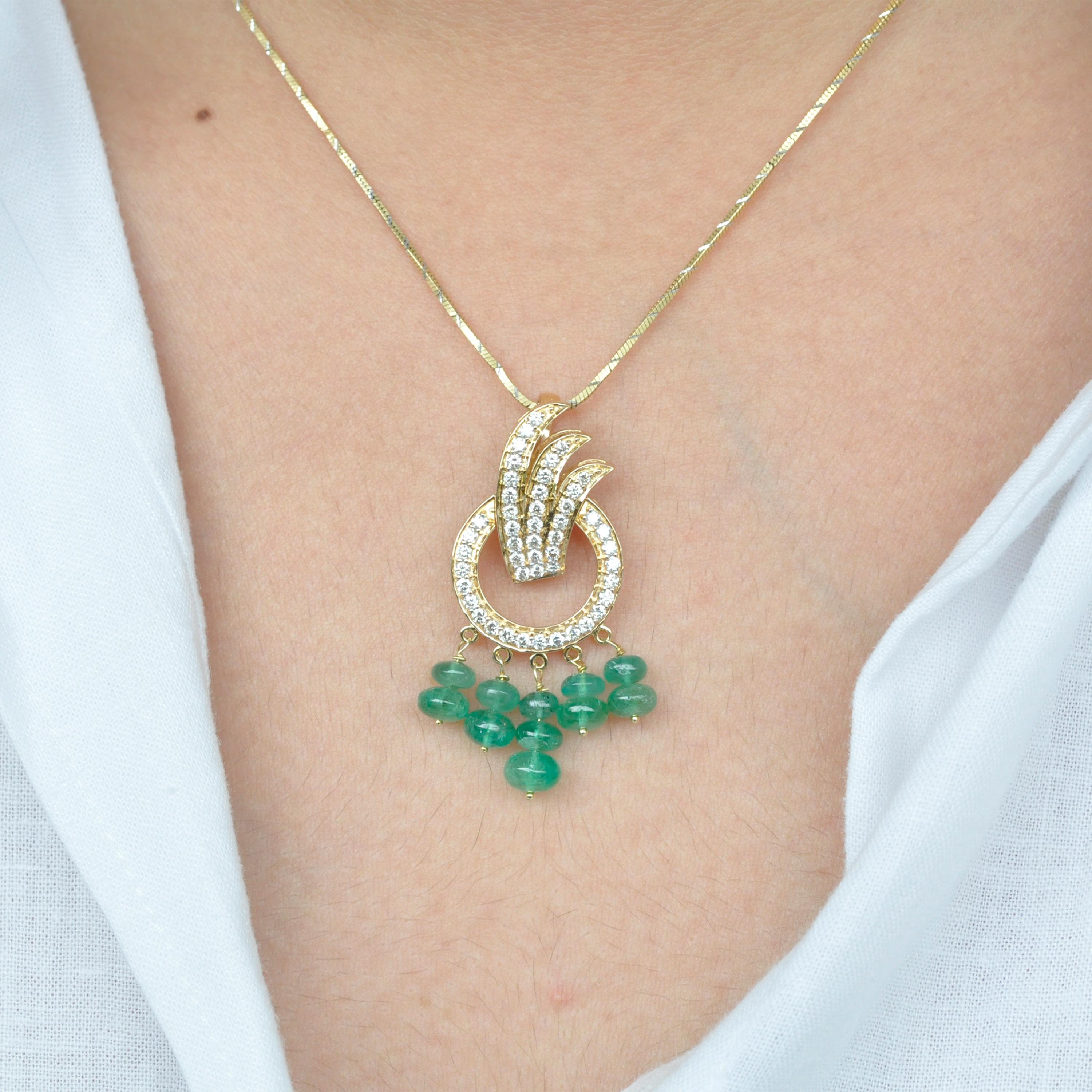18 karat yellow gold diamond zambian emerald beads pendant necklace

This 18 karat gold pendant necklace is a handcrafted contemporary beauty. The pendant depicts three diamond feathers encircled by a diamond ring. A touch of green added by the