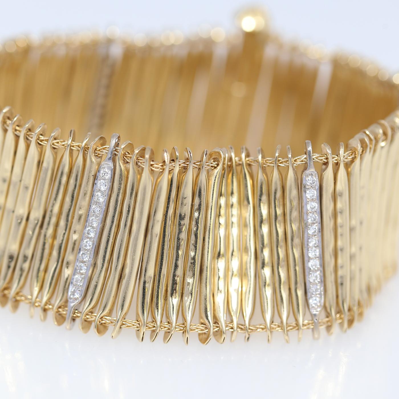 Fine 18K Yellow Gold bracelet with round-cut Diamonds. Immaculately executed bracelet comprising of Gold and Diamonds pods connected together. The structure emerges as a second skin on a hand. Long pin and security chain makes it easy to open and