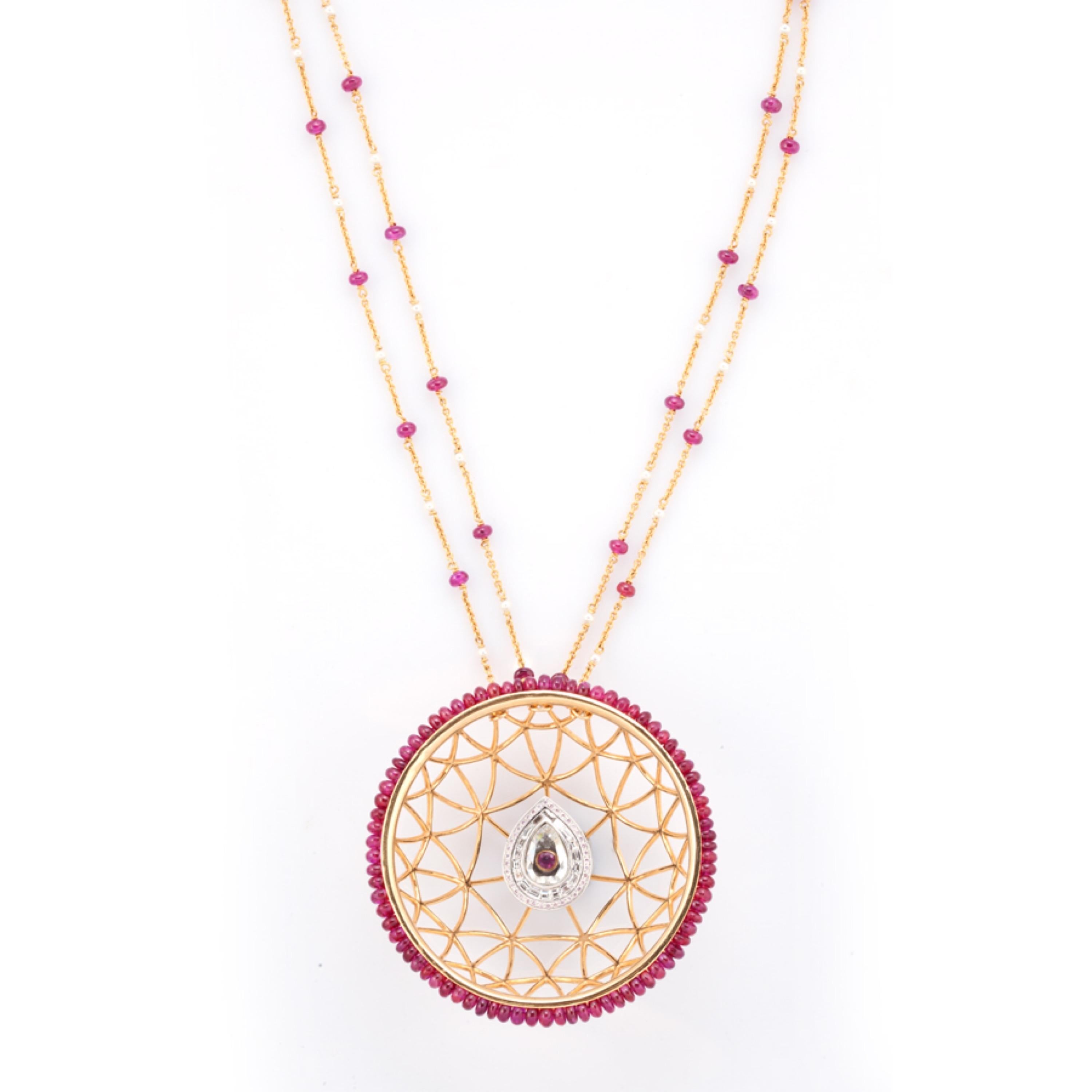 Tessellated techniques favored by the Dutch graphic artist MC Escher inspire this stunning D’Joya piece. Innovation comes from gold wires used to depict a spider’s web, which form a circular pendant bordered by 38 unheated Tajikistan ruby beads. The