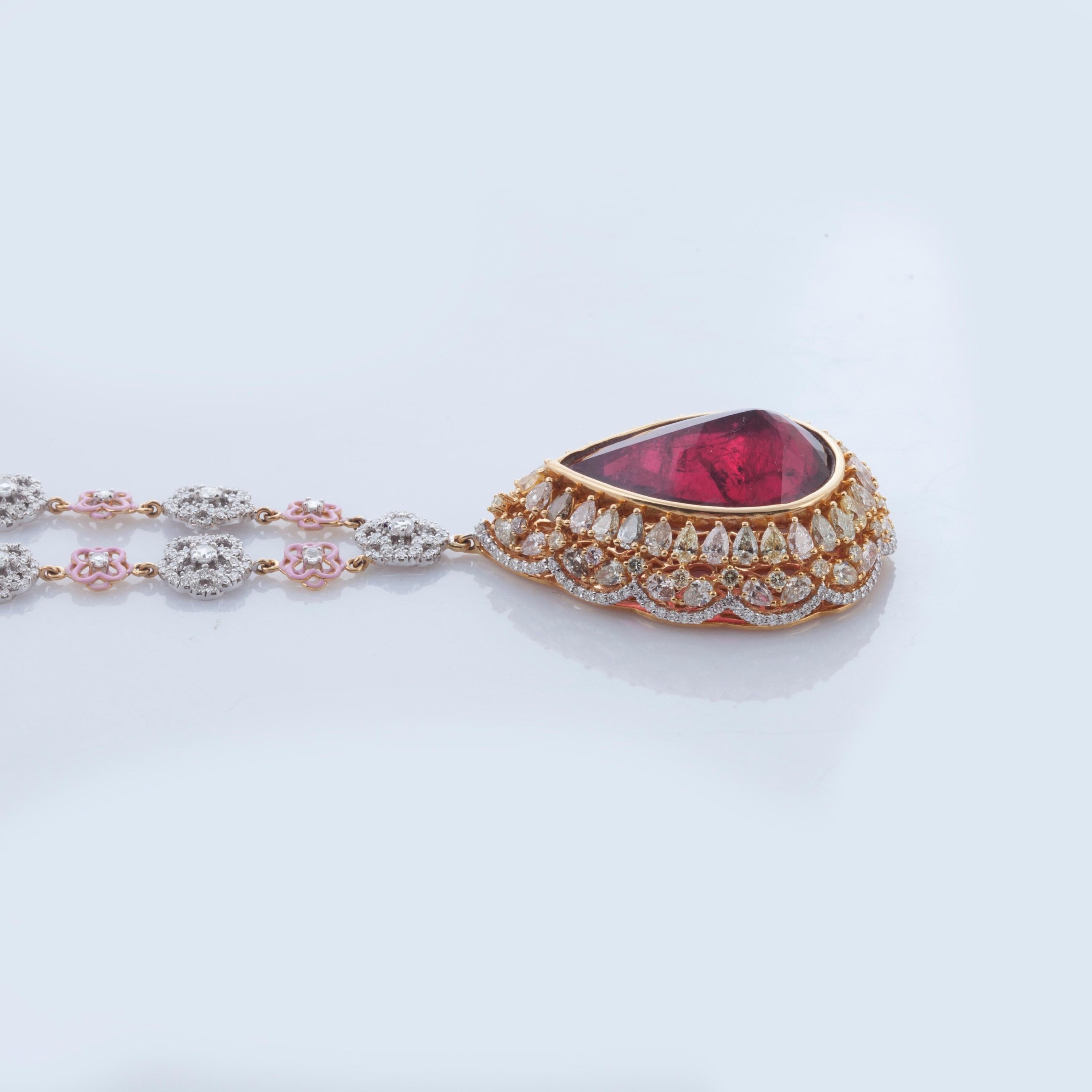 The rosette window above the beautiful gateway of the Strasbourg Cathedral envelopes the beautiful 25.51 carat Rubelite set in reverse with natural fancy colored Pear Shaped diamonds suspended on a beautiful Rosetta motif alternately studded in