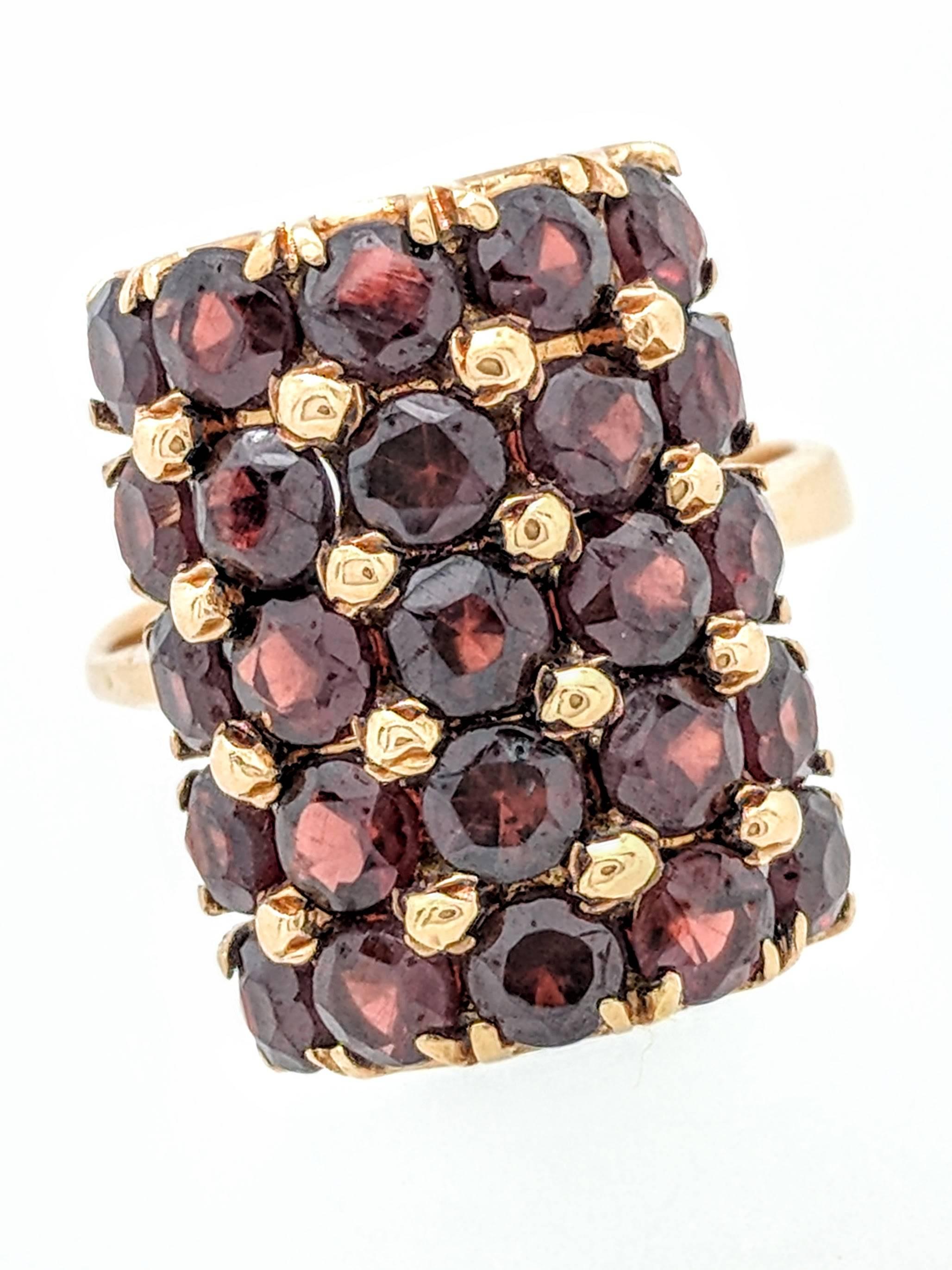 Ladies 18k Yellow Gold Dome Multi Row Garnet Ring Size 5

You are viewing a beautiful ladies dome multi row Garnet Gemstone ring.  This ring is crafted from 18k yellow gold and weighs 7.8 grams.  It features (25) .05ct natural round prong set