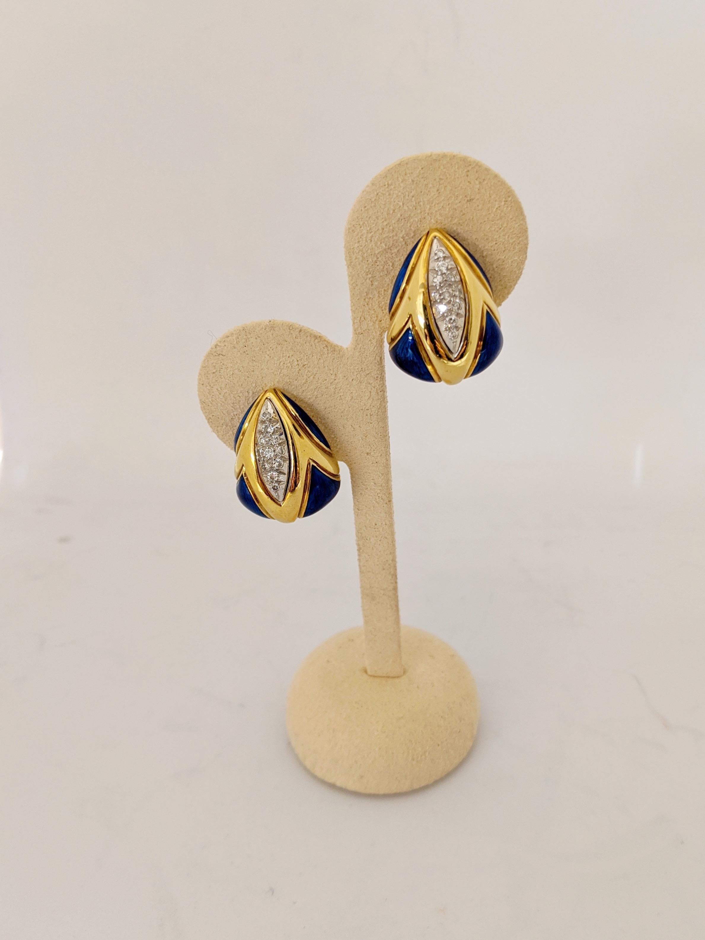 These 18 karat yellow gold earrings are a triangular shape. The earrings are set with pave diamonds and polished sections of Lapis in geometric shapes. They have a french clip back and are suitable for pierced and non pierced wearers. They measure