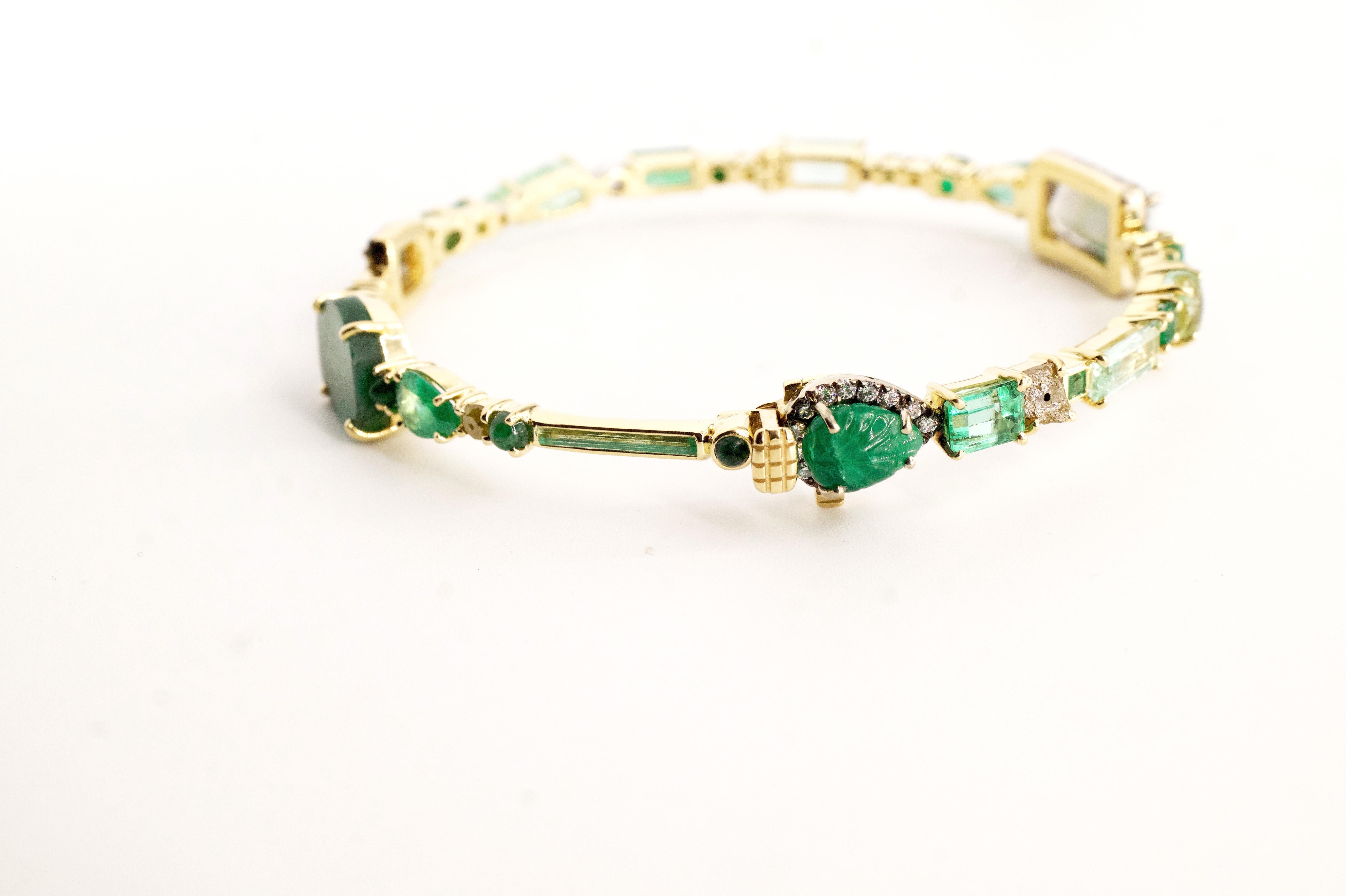 Emerald Baby Bangle 
An eighteen-karat yellow gold hinged bangle set entirely with white diamonds and emeralds in a variety of shapes and sizes
Diamond Total Weight – 1.49 cts.
Gemstone Total Weight – 18.63 cts.
This piece is one-of-a-kind and