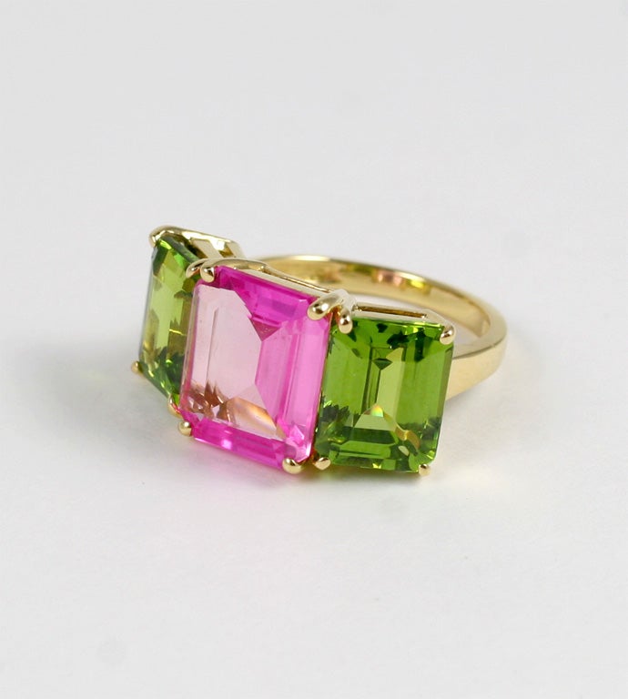 18kt yellow gold Emerald Cut ring with Pink Topaz (approximately 5 cts) and Peridot (approximately 4 cts each).

The ring Measures approximately 1 inch across and 1/2 high.

This emerald cut ring can be made in any ring size and with any colored